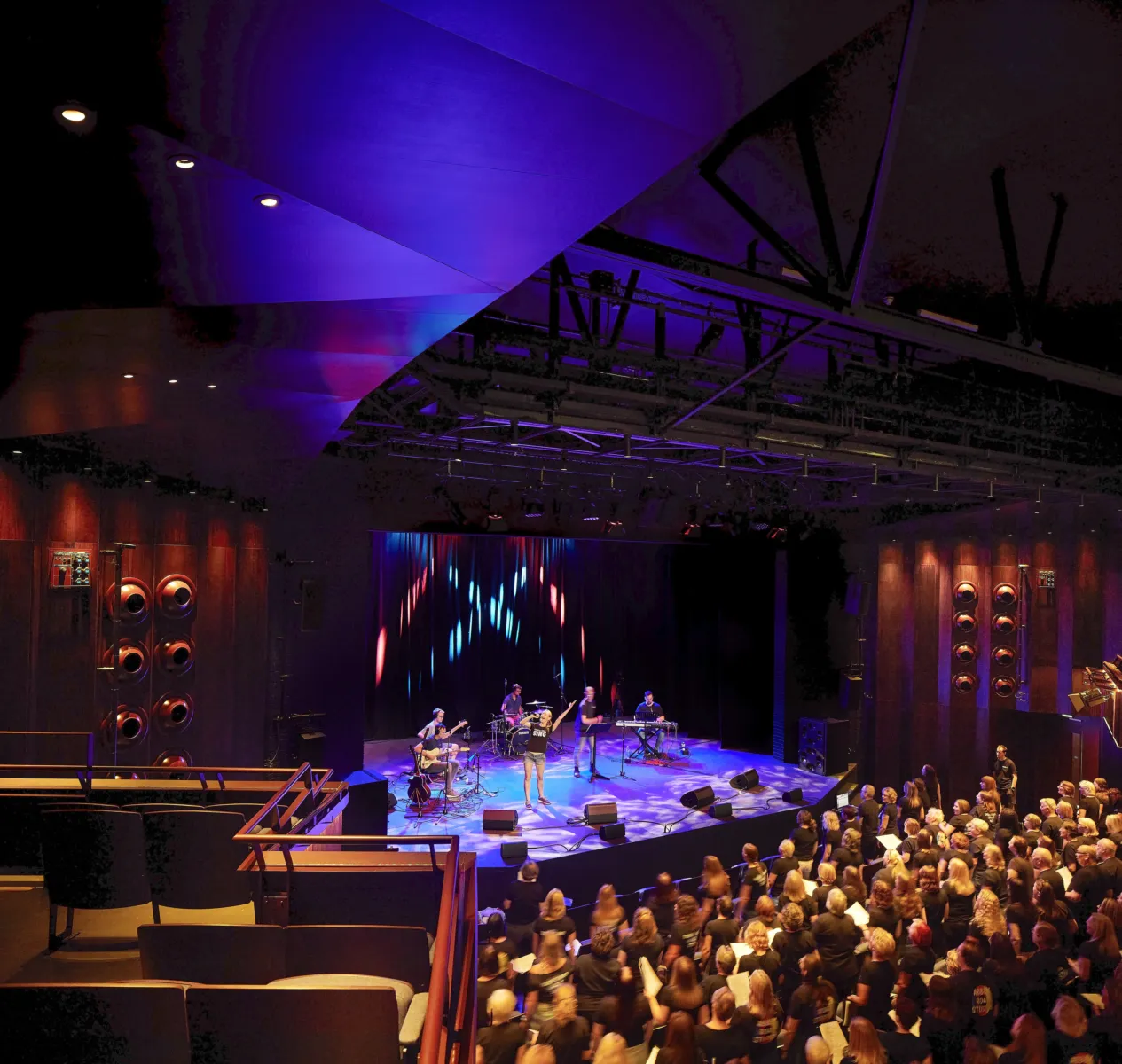 theatre showing people watching performers onstage