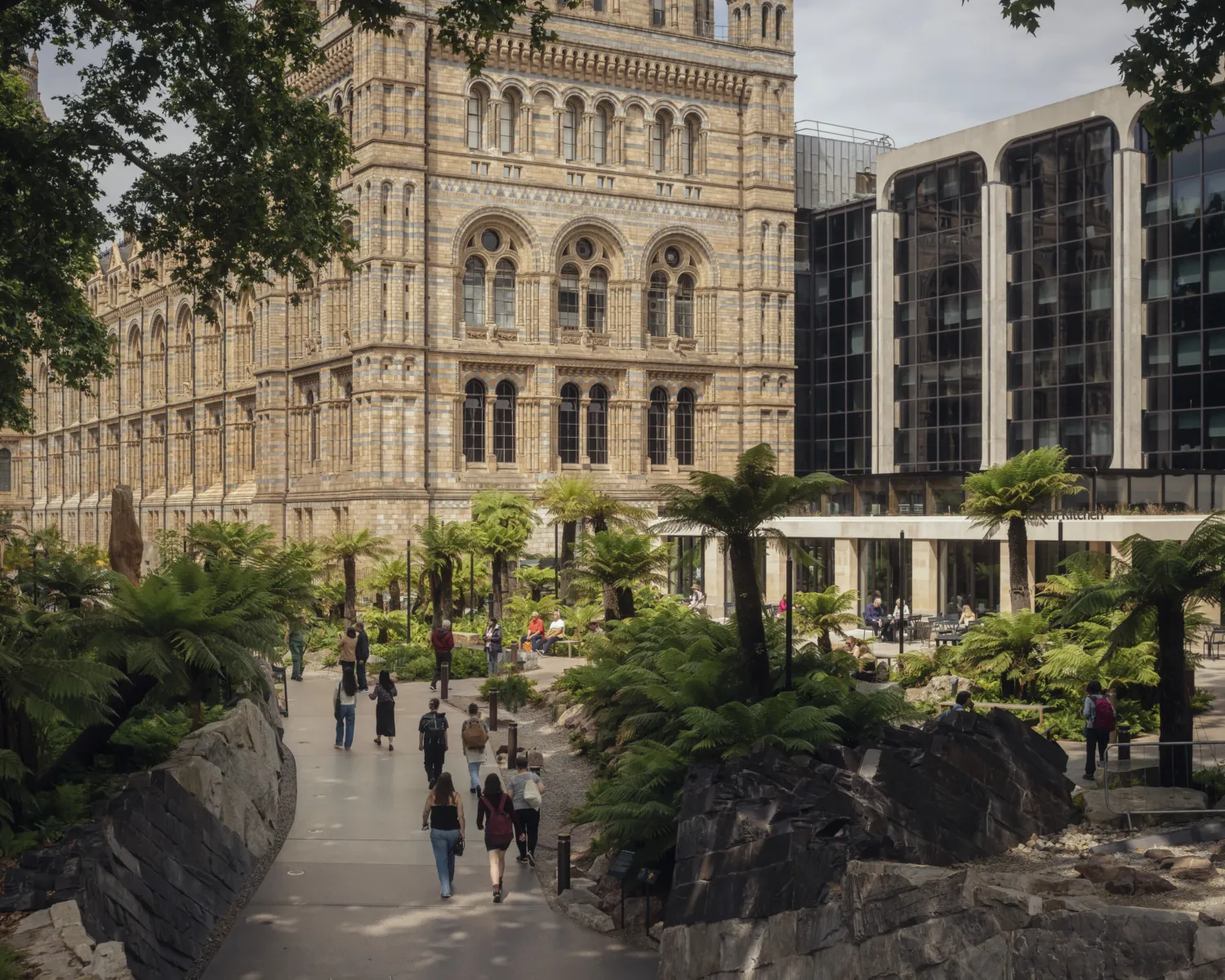 Historic building in the background with leafy garden in front
