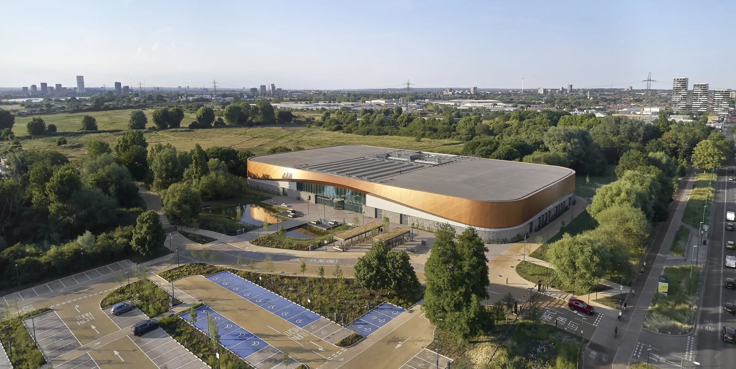 large building with a wooden facade next to parking lot