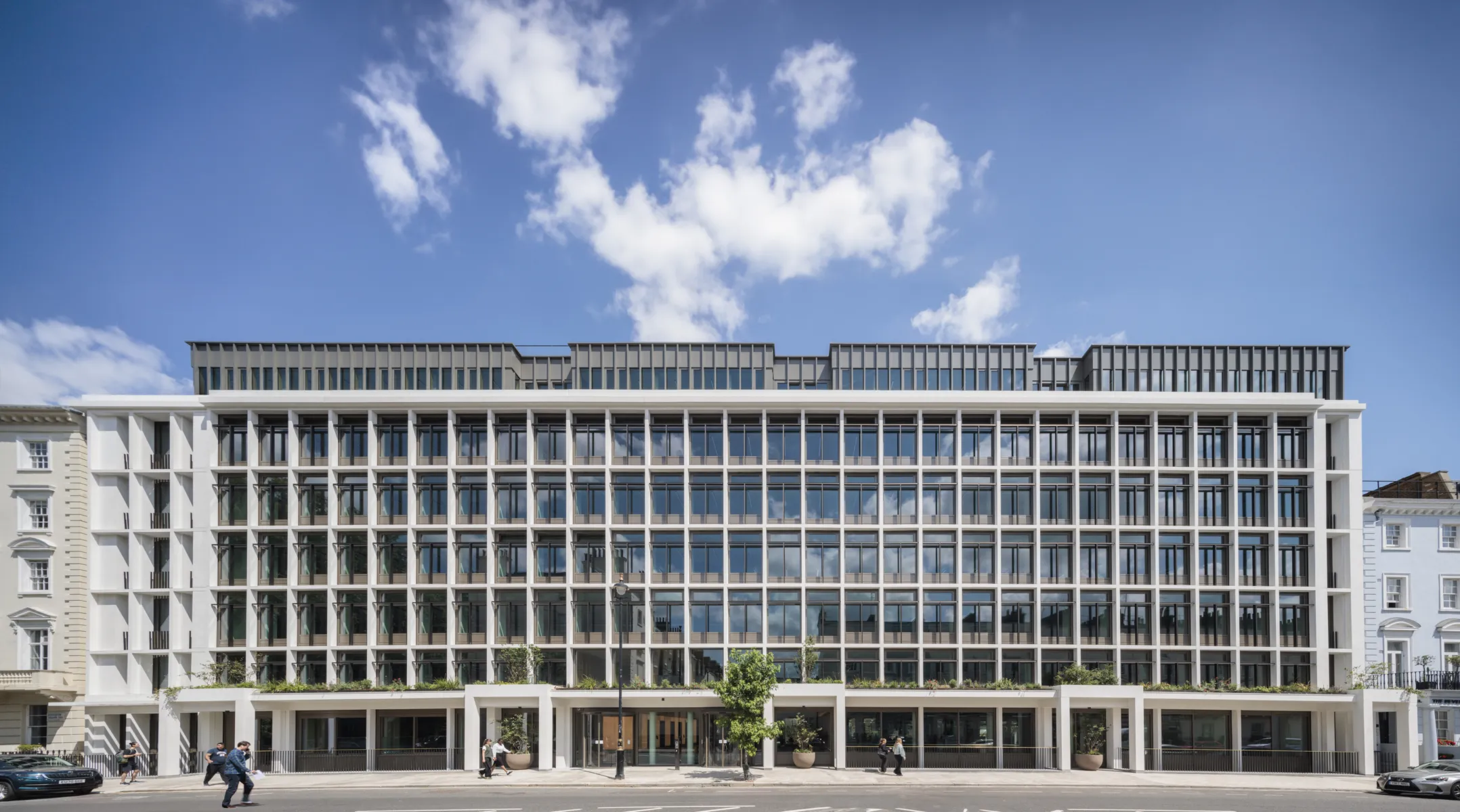 The image shows the external facade of a modern large office building