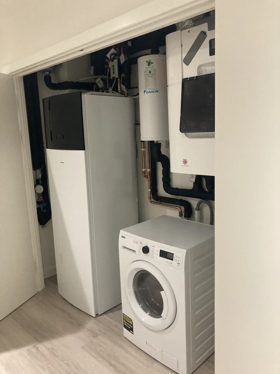 Closet showing washing machine and service equipment