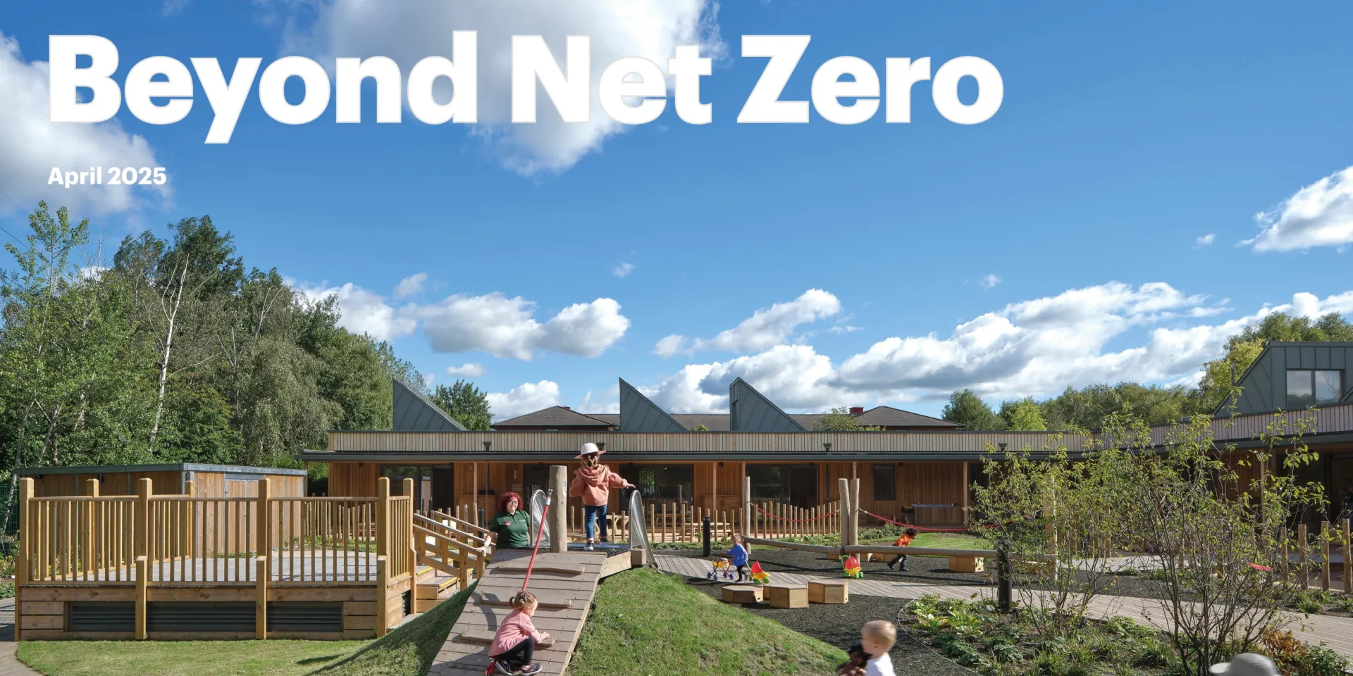 Image shows children playing on a playground in front of a school