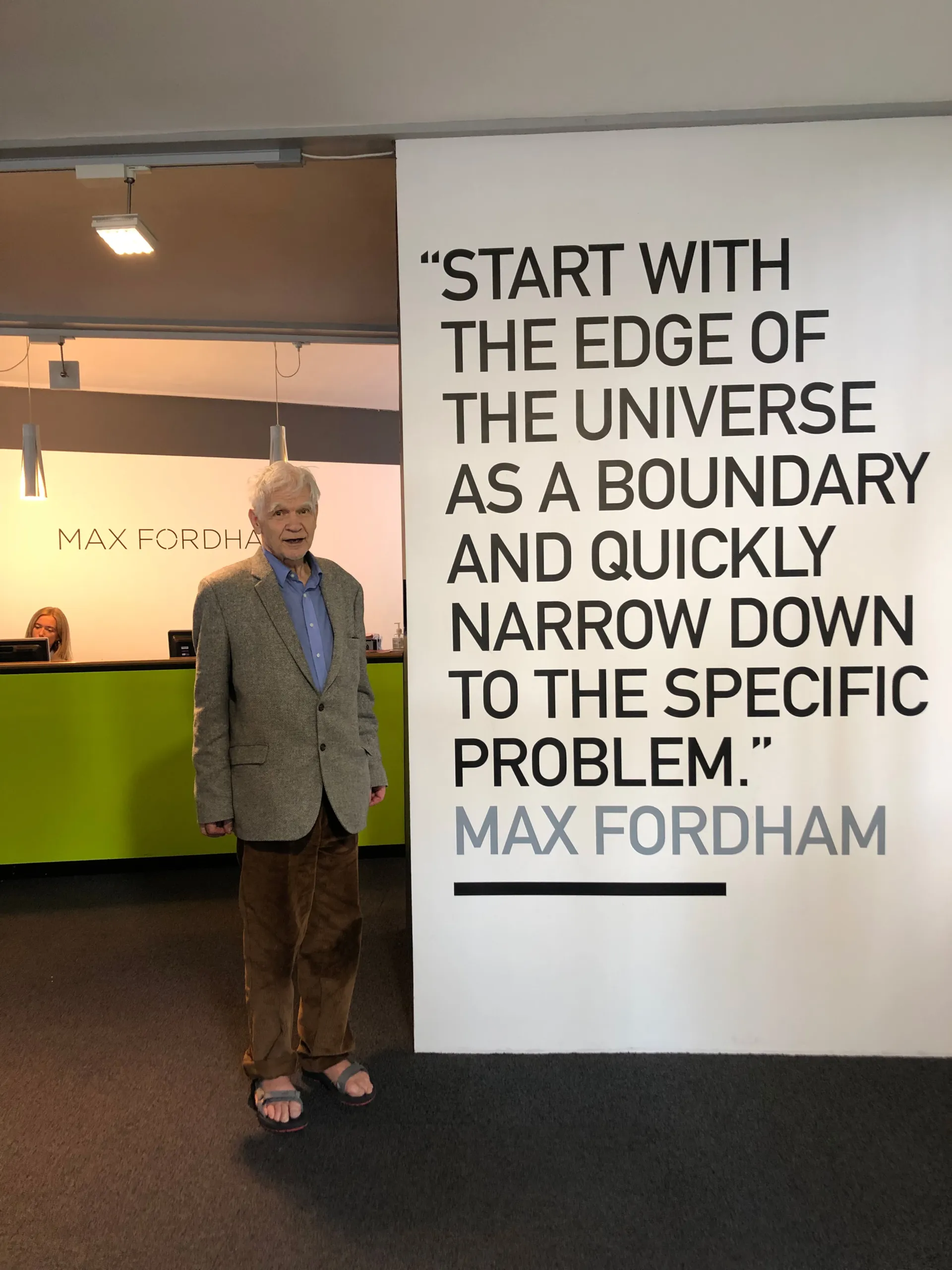 Max Fordham in the London office next to his quote at the reception