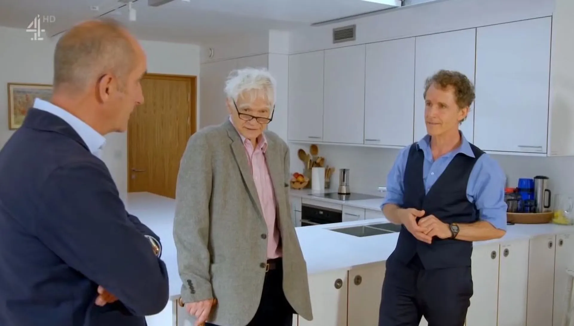 Still of Max being interviewed in his new house by Kevin McCloud on Grand Designs, with Justin Bere.