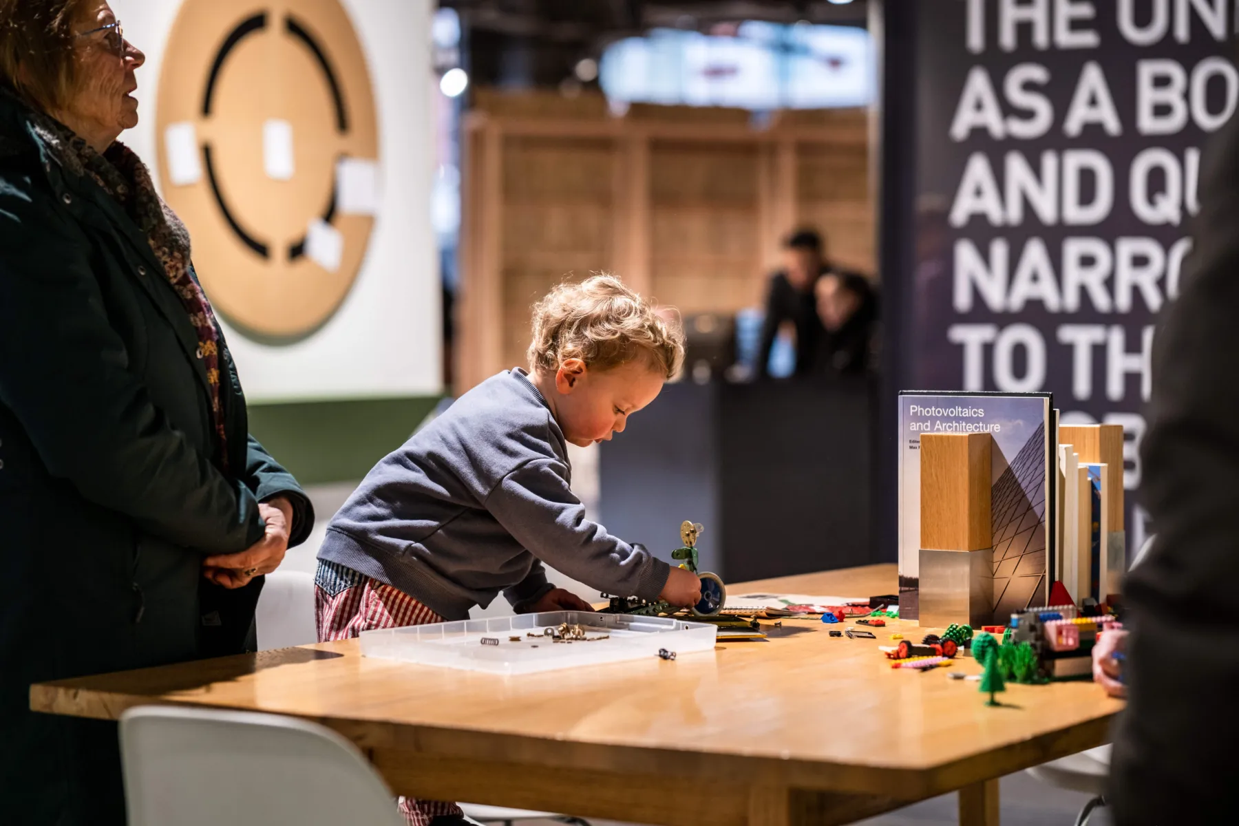 A child playing with Meccano on the table