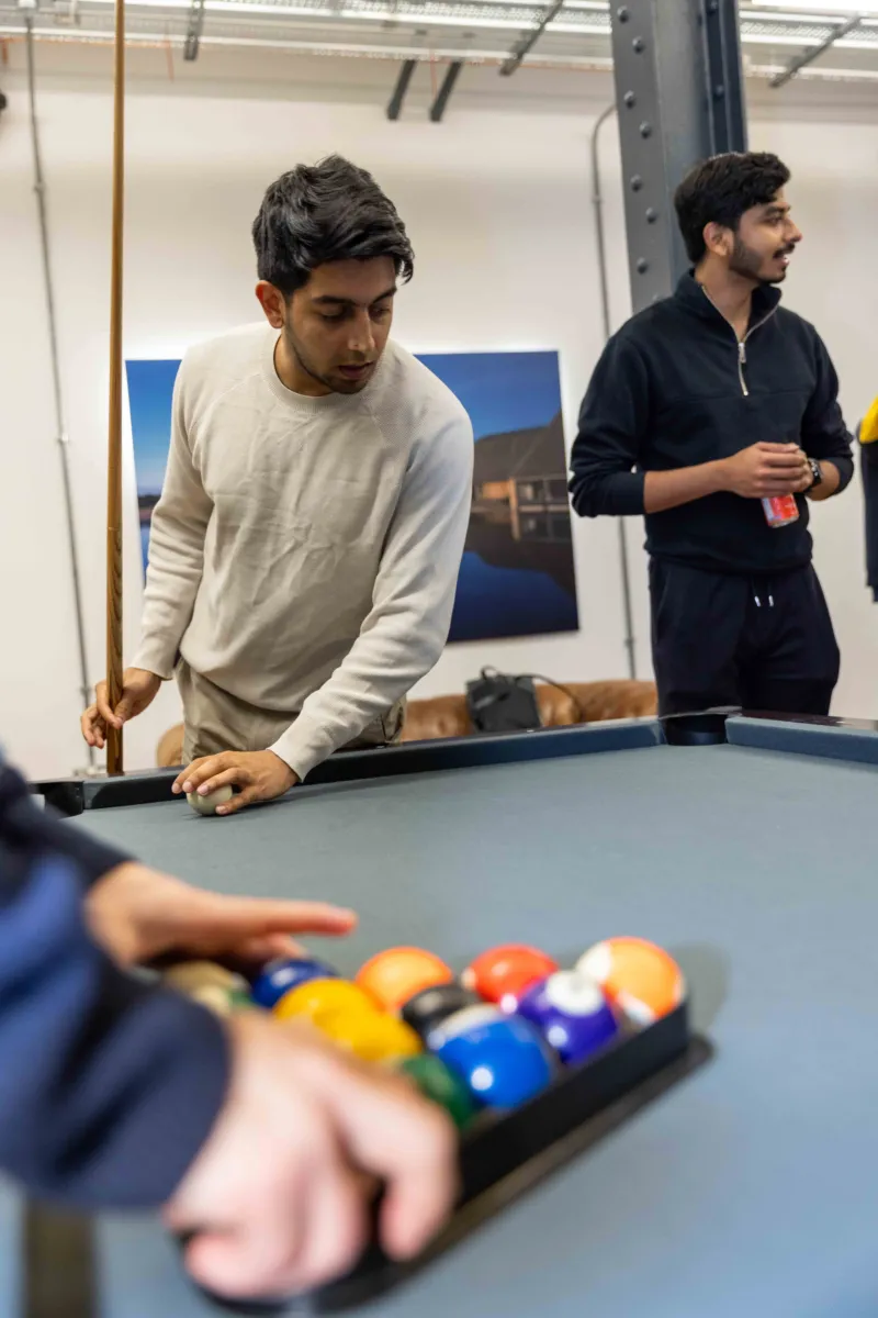 Close-up shot of two men playing pool.