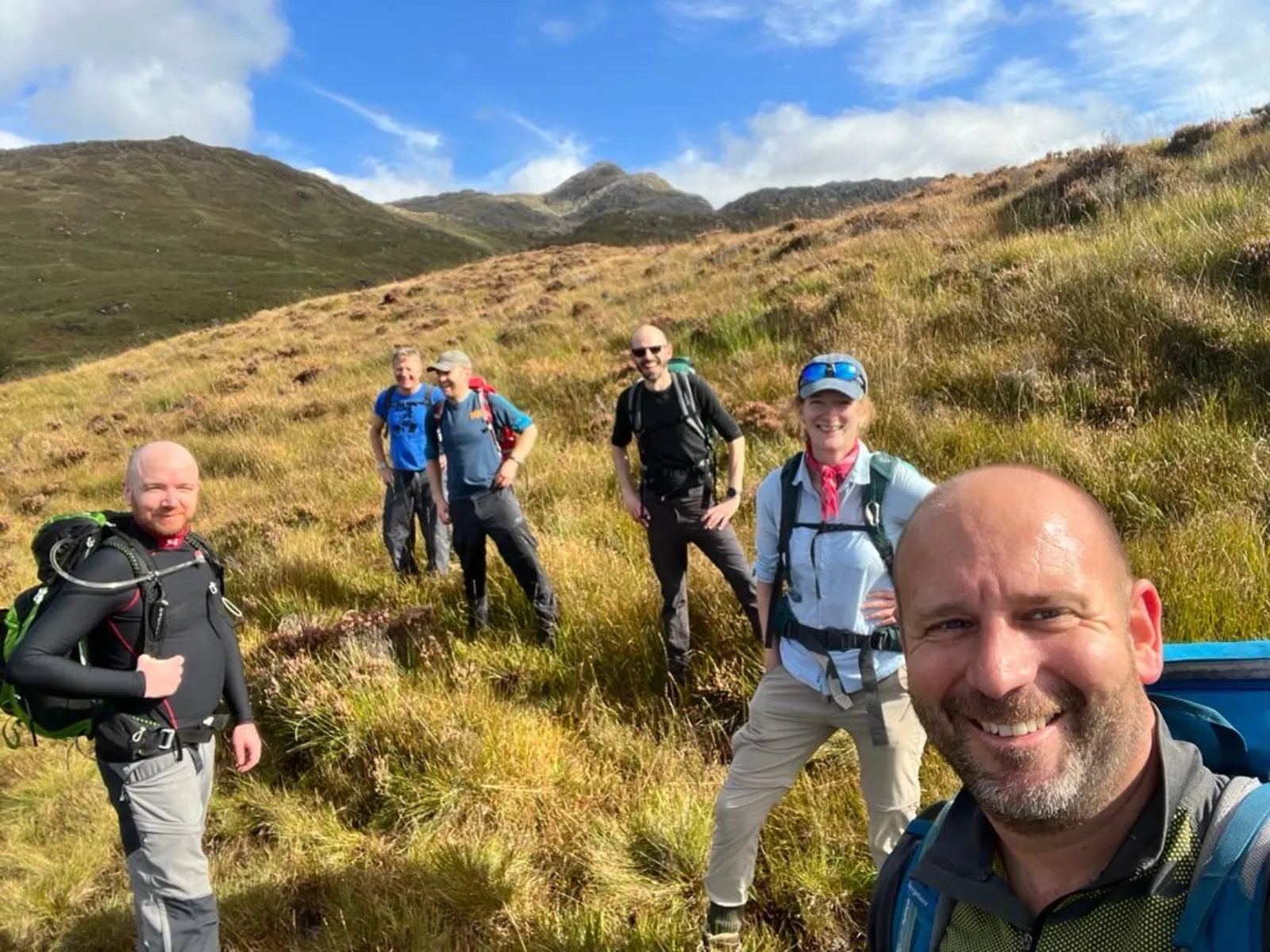 A group of people hiking on a sunny day