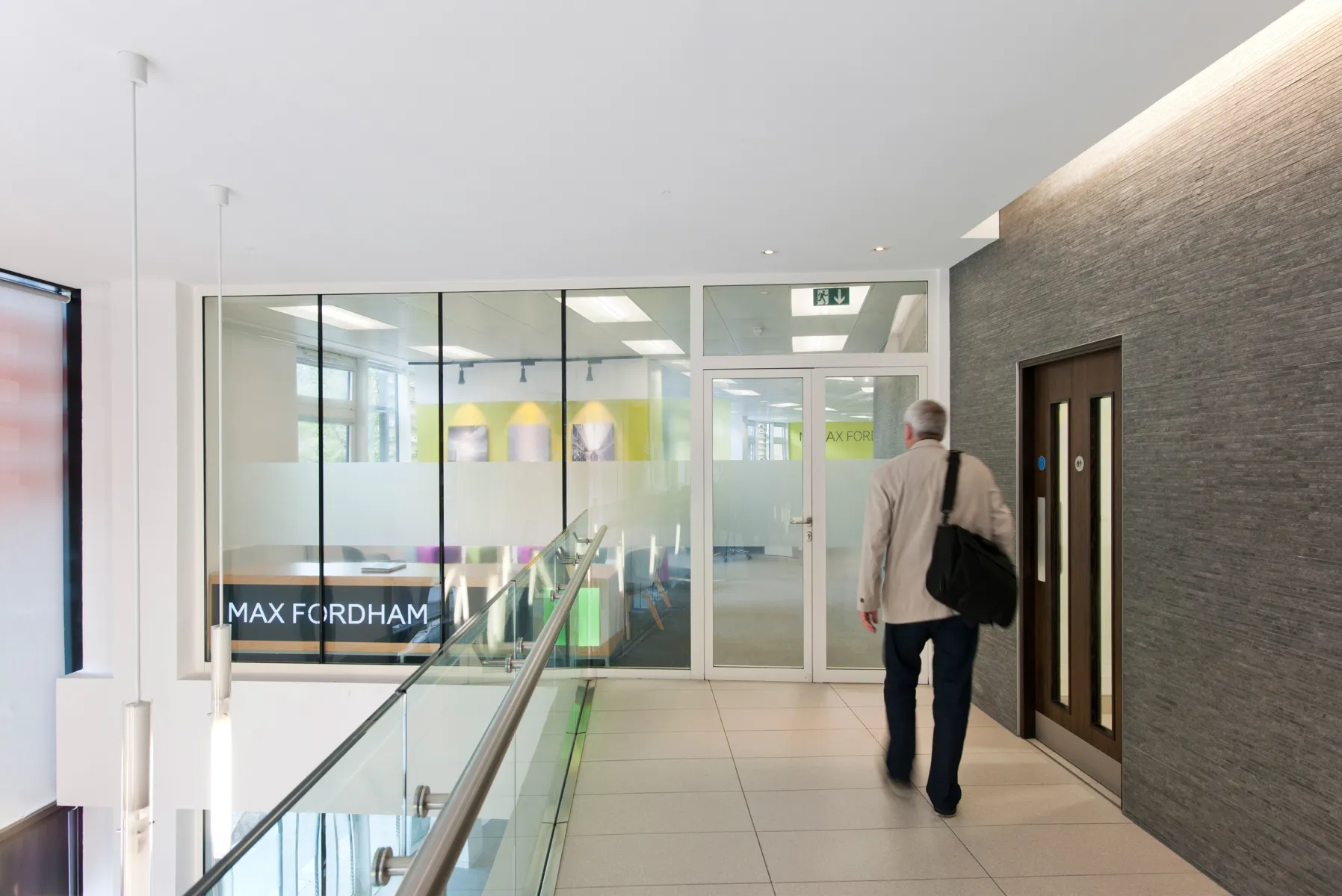 Man walking into Max Fordham Edinburgh office, past a lift