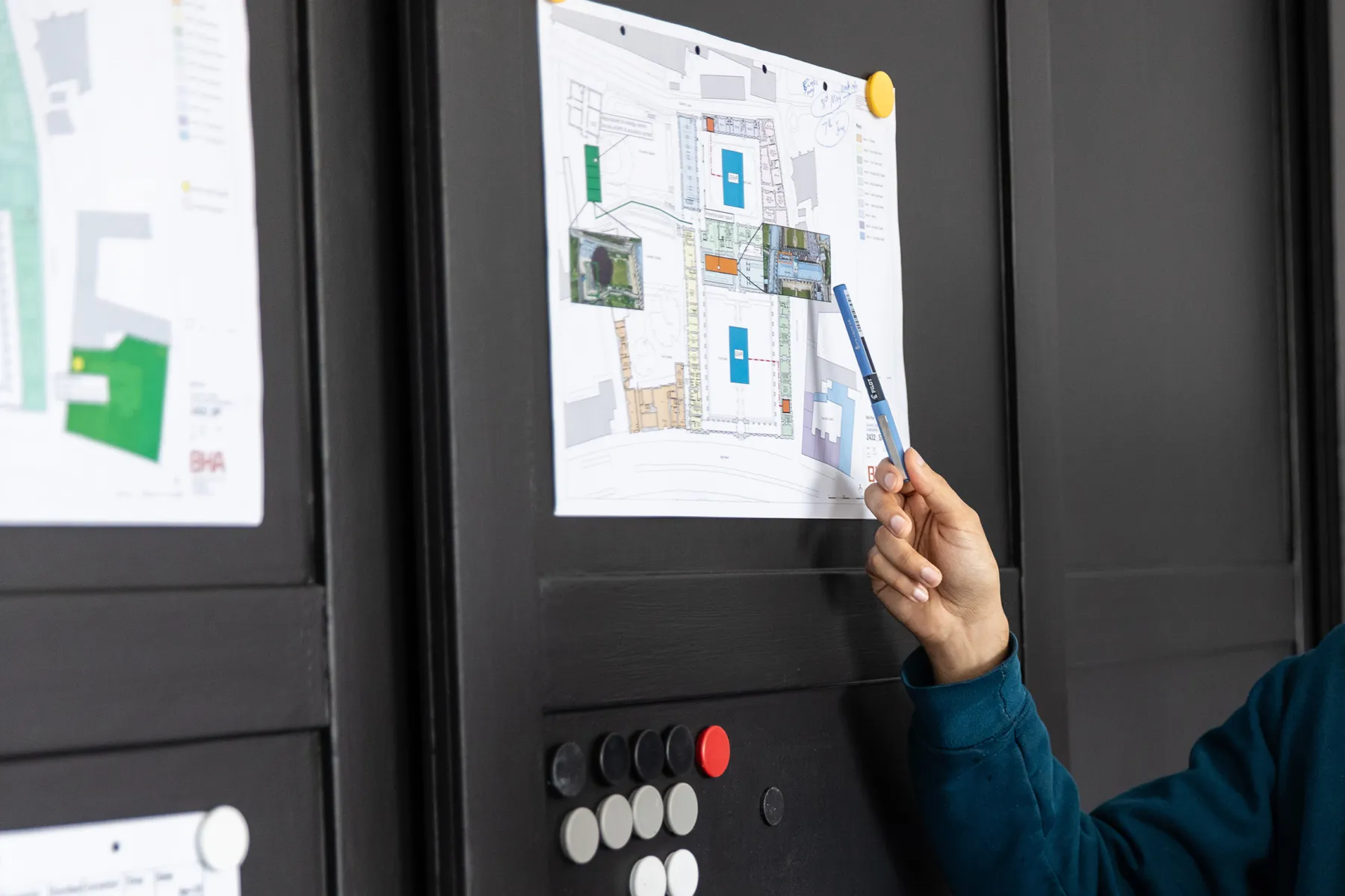 Close-up photo of hand pointing at drawing