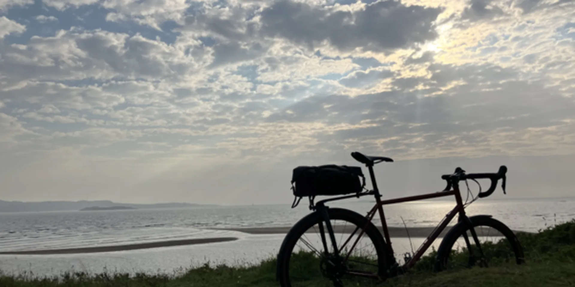 Seven people wearing sports clothes with their bicycles