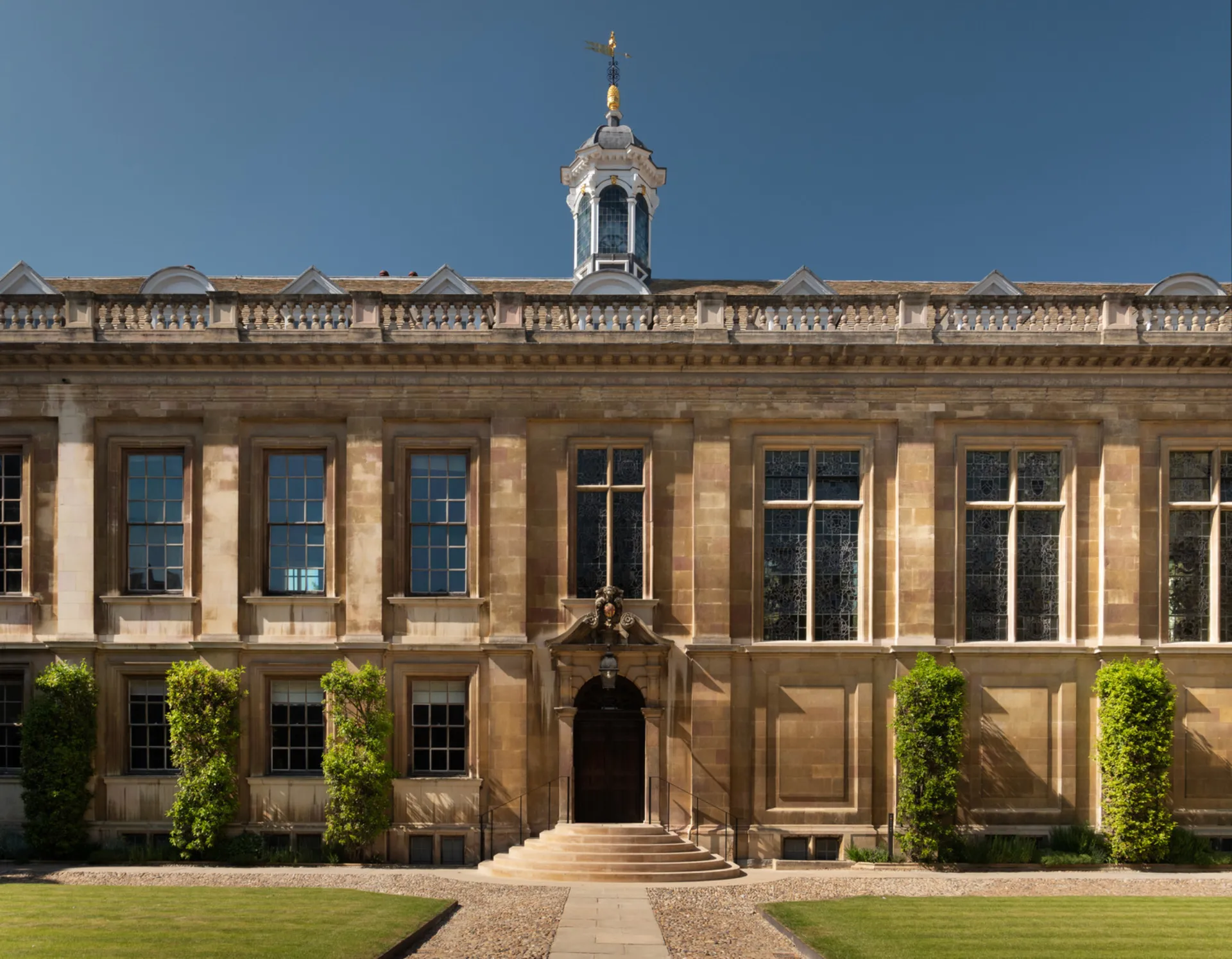 Facade of a historic and majestic building with stone steps at the front