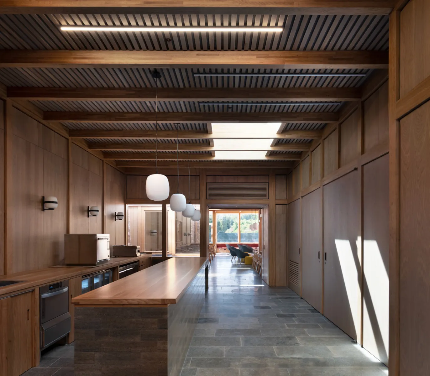 wood-panelled modern room with skylights and window