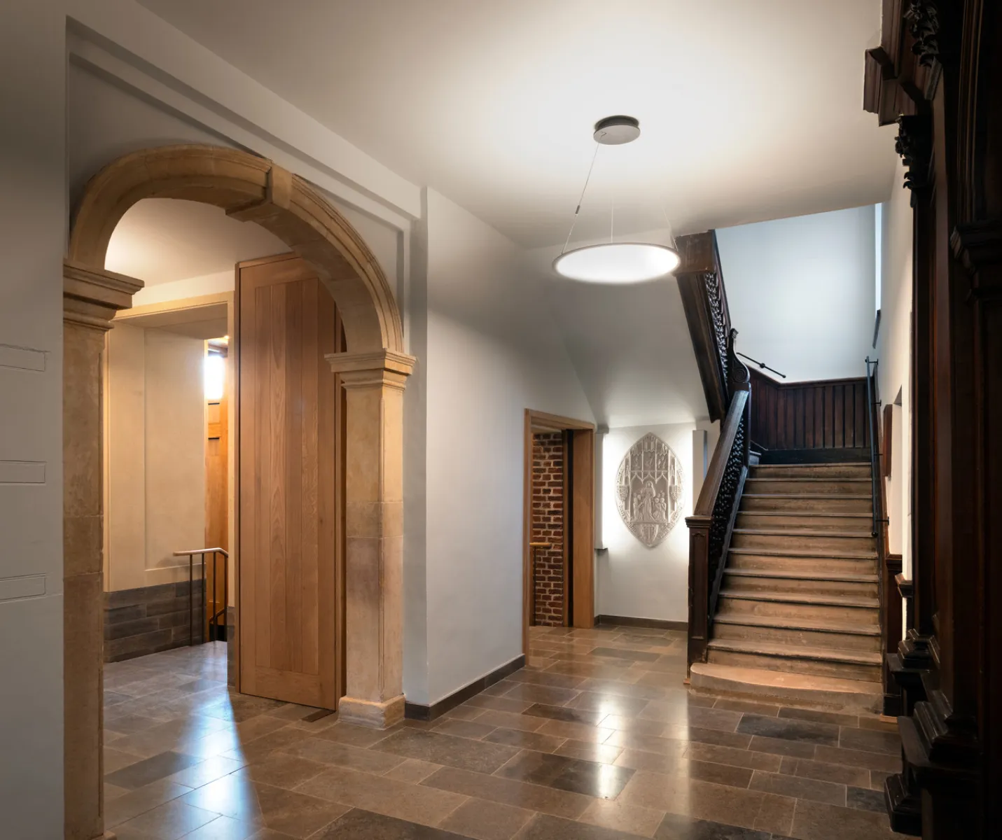 Historic building with stone floors, archway and staircase