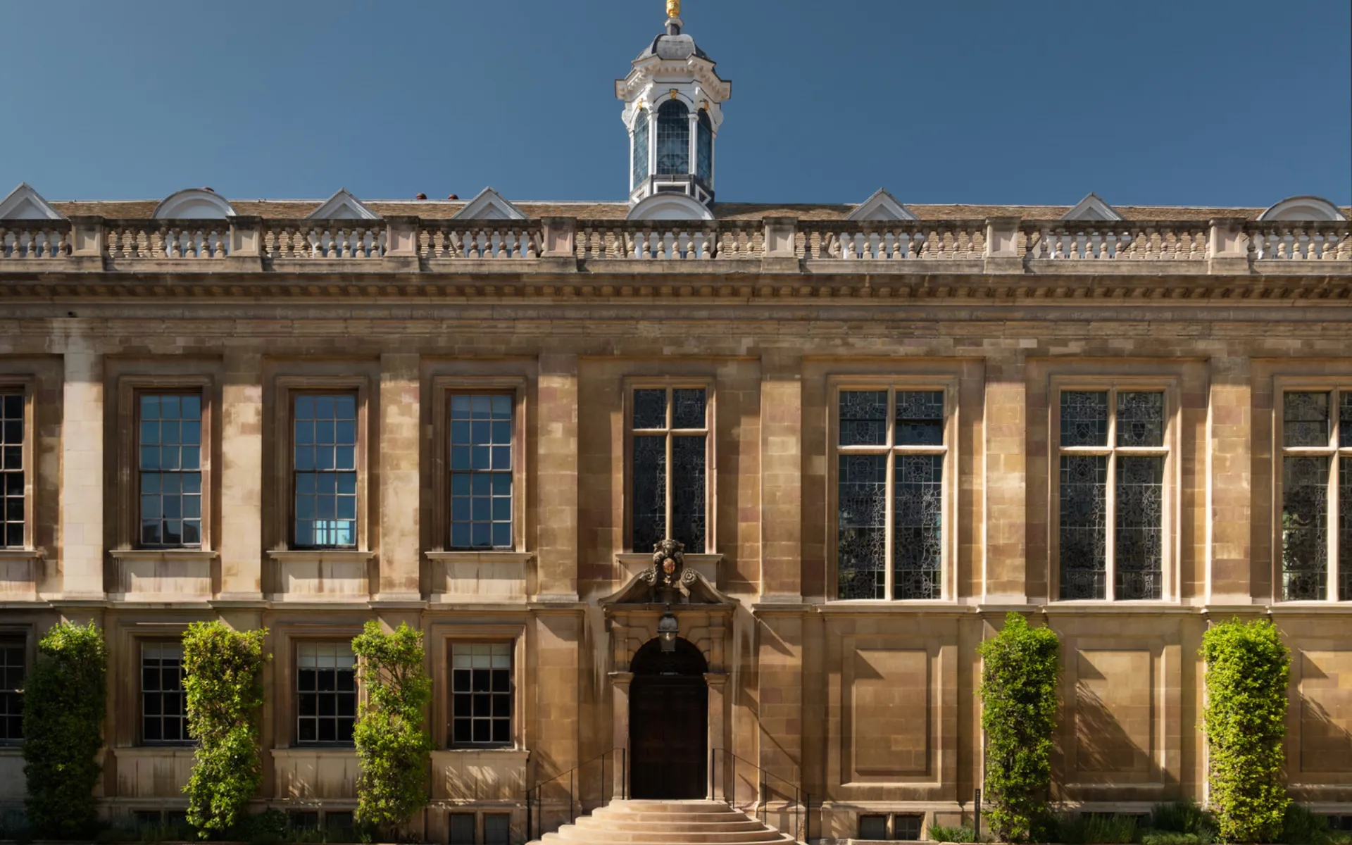 Facade of a historic and majestic building with stone steps at the front