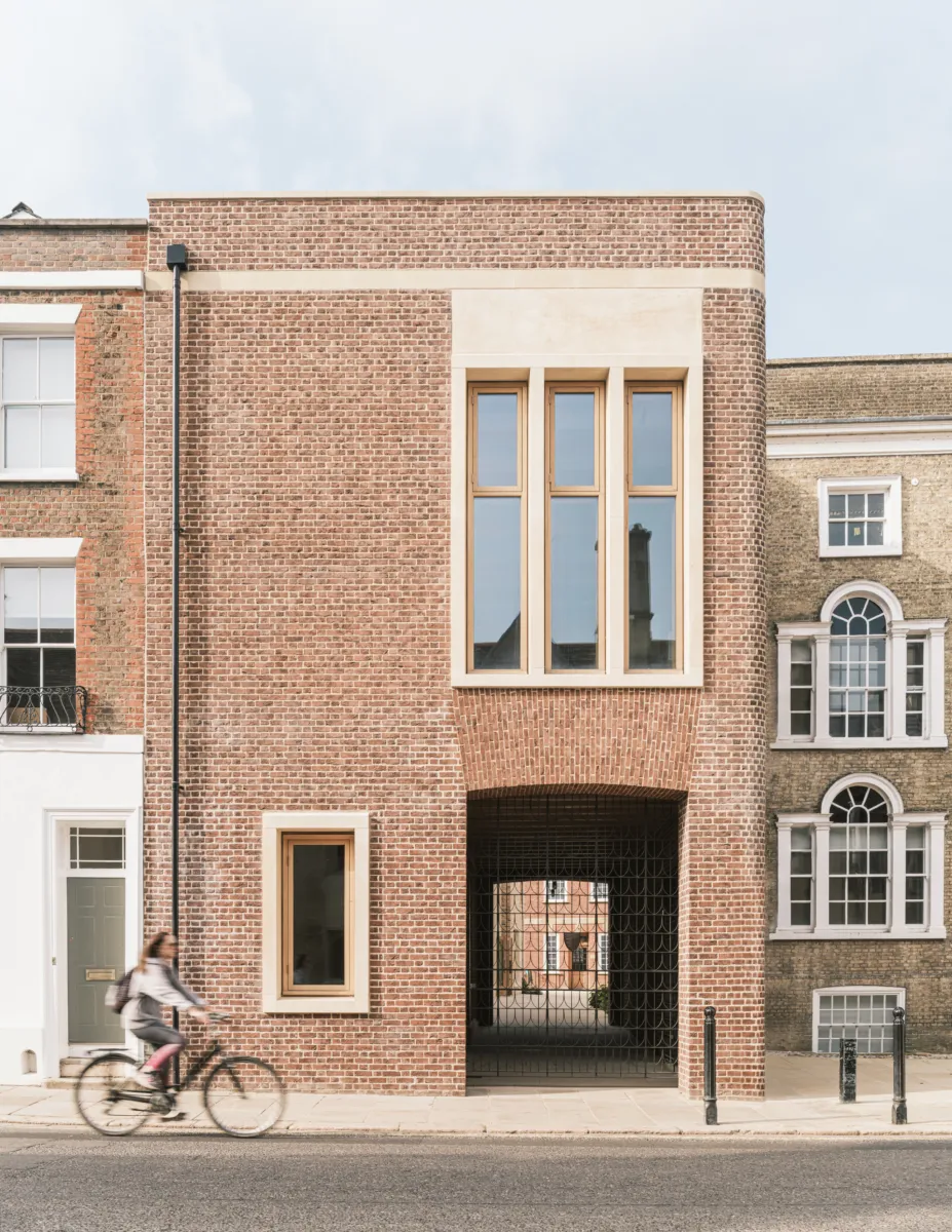 Brick entrance with an iron gate into campus