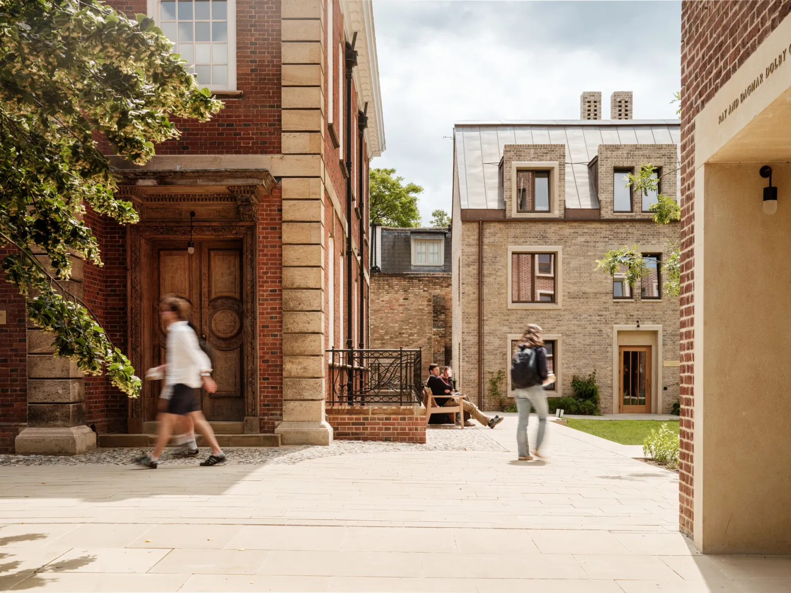 Campus with students walking around old and new buildings