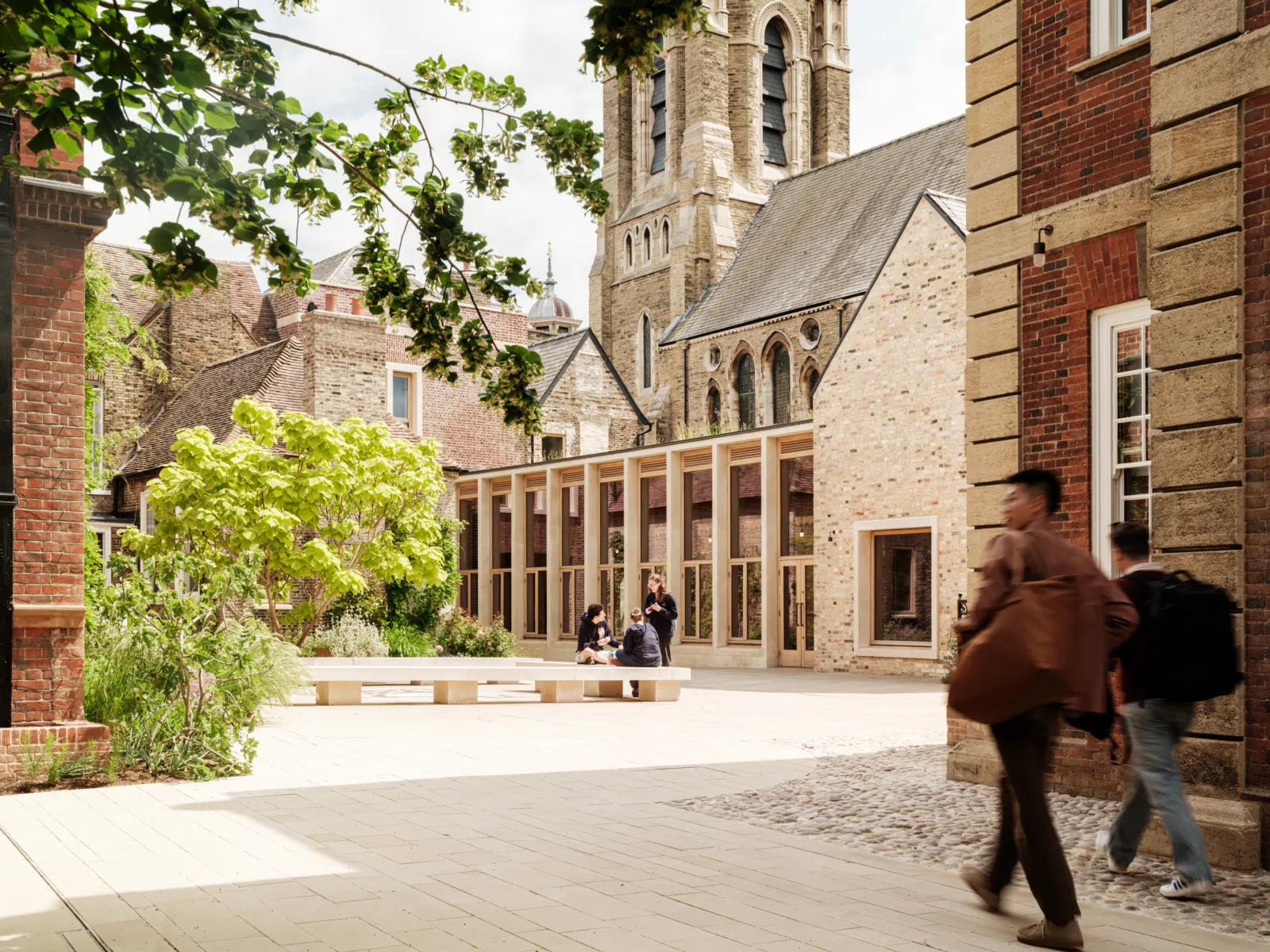 campus with students walking around a mix of old and new buildings
