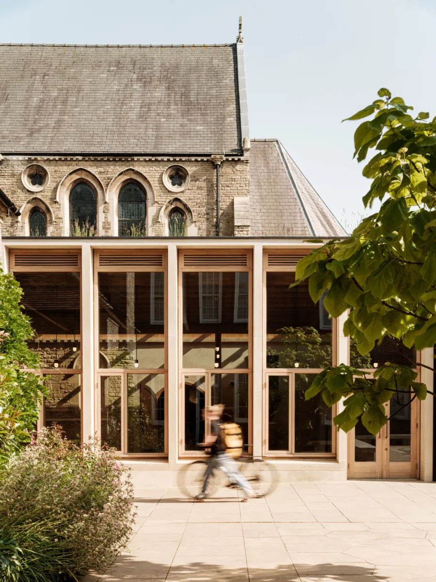 modern glass and wooden extension to a historic building