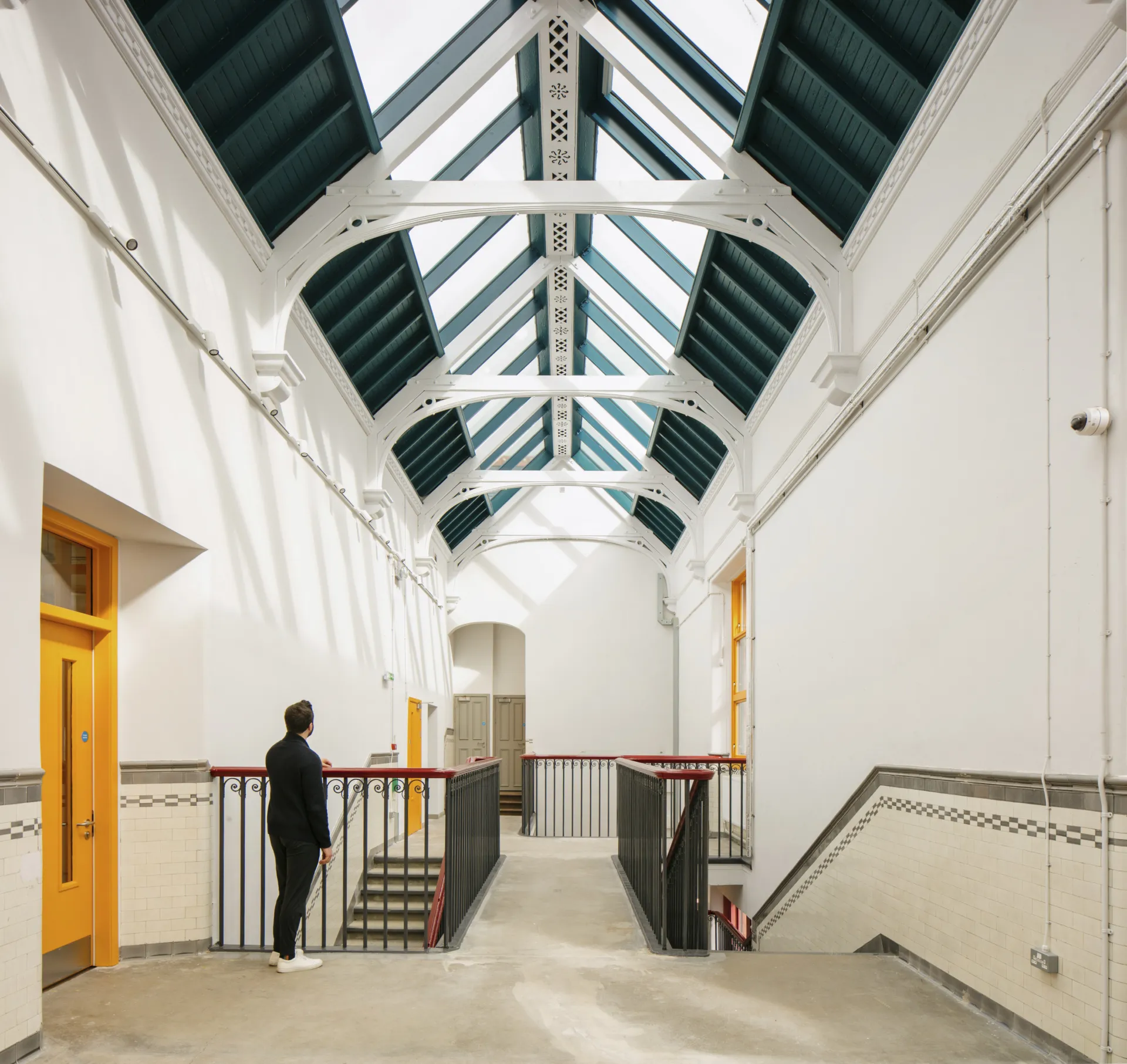 An interior hallway of a building lit by rooflights