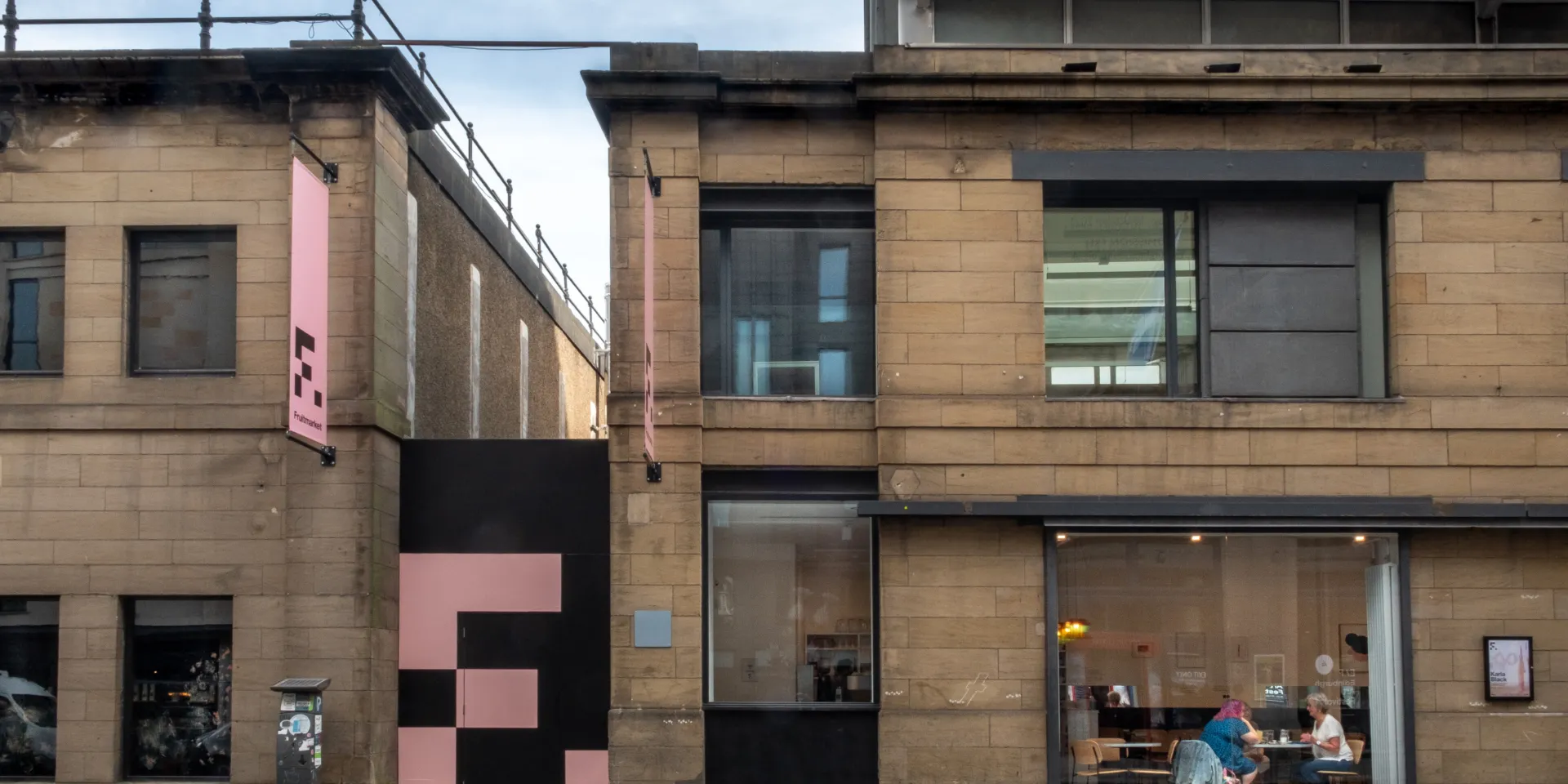 The exterior of a two storey stone-fronted building