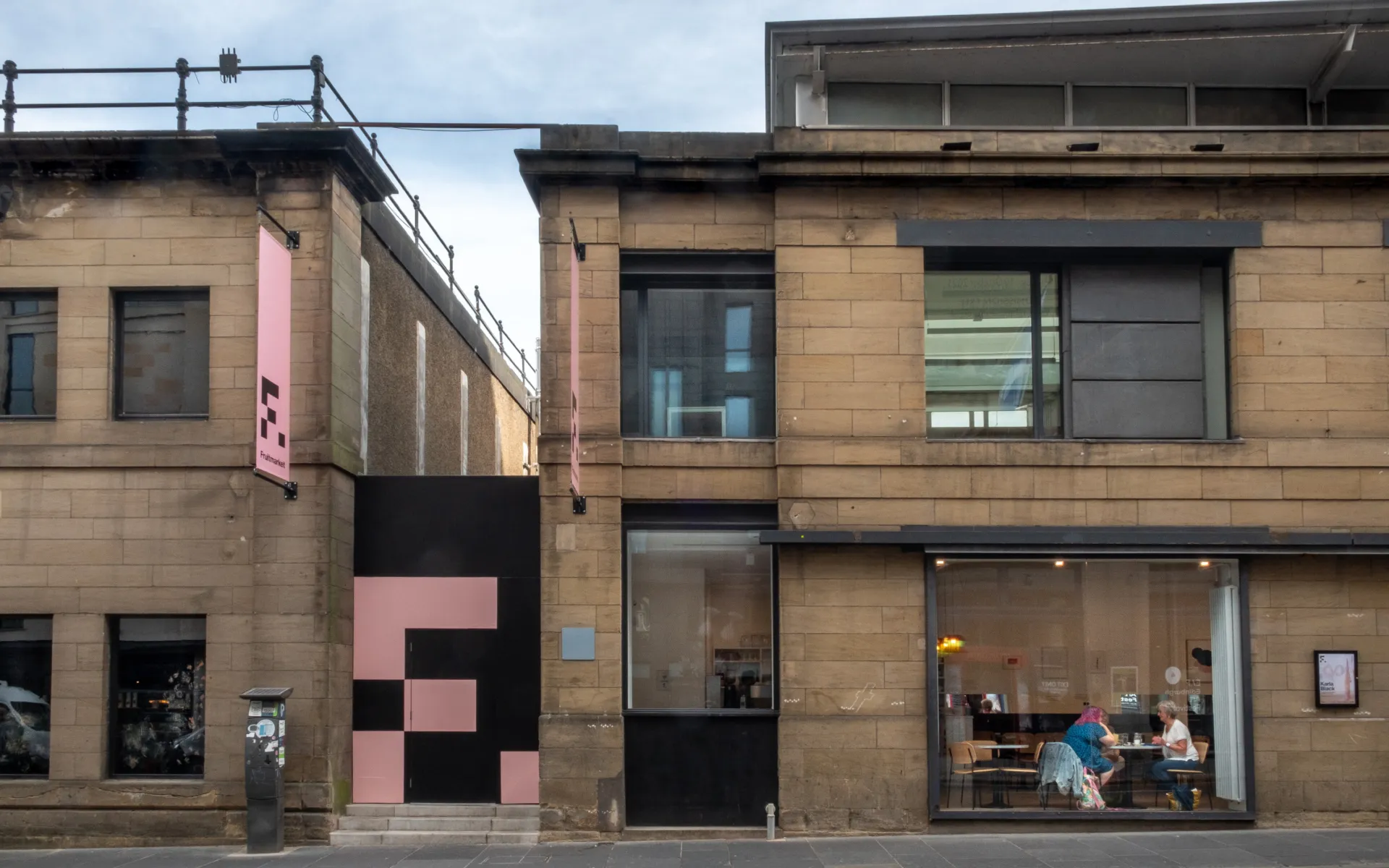 The exterior of a two storey stone-fronted building