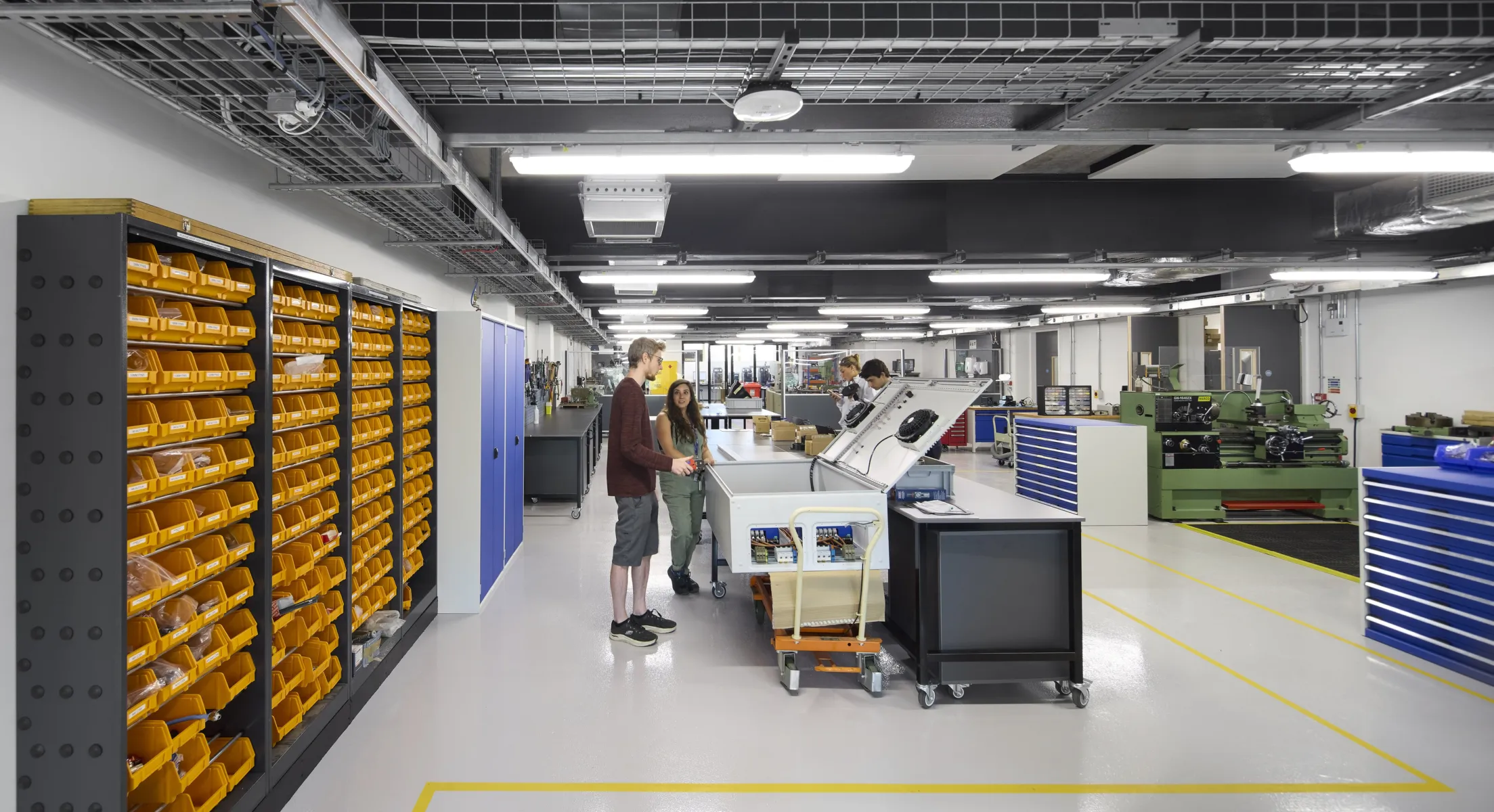 Workshop space with researchers working among tools, equipment and workbenches.