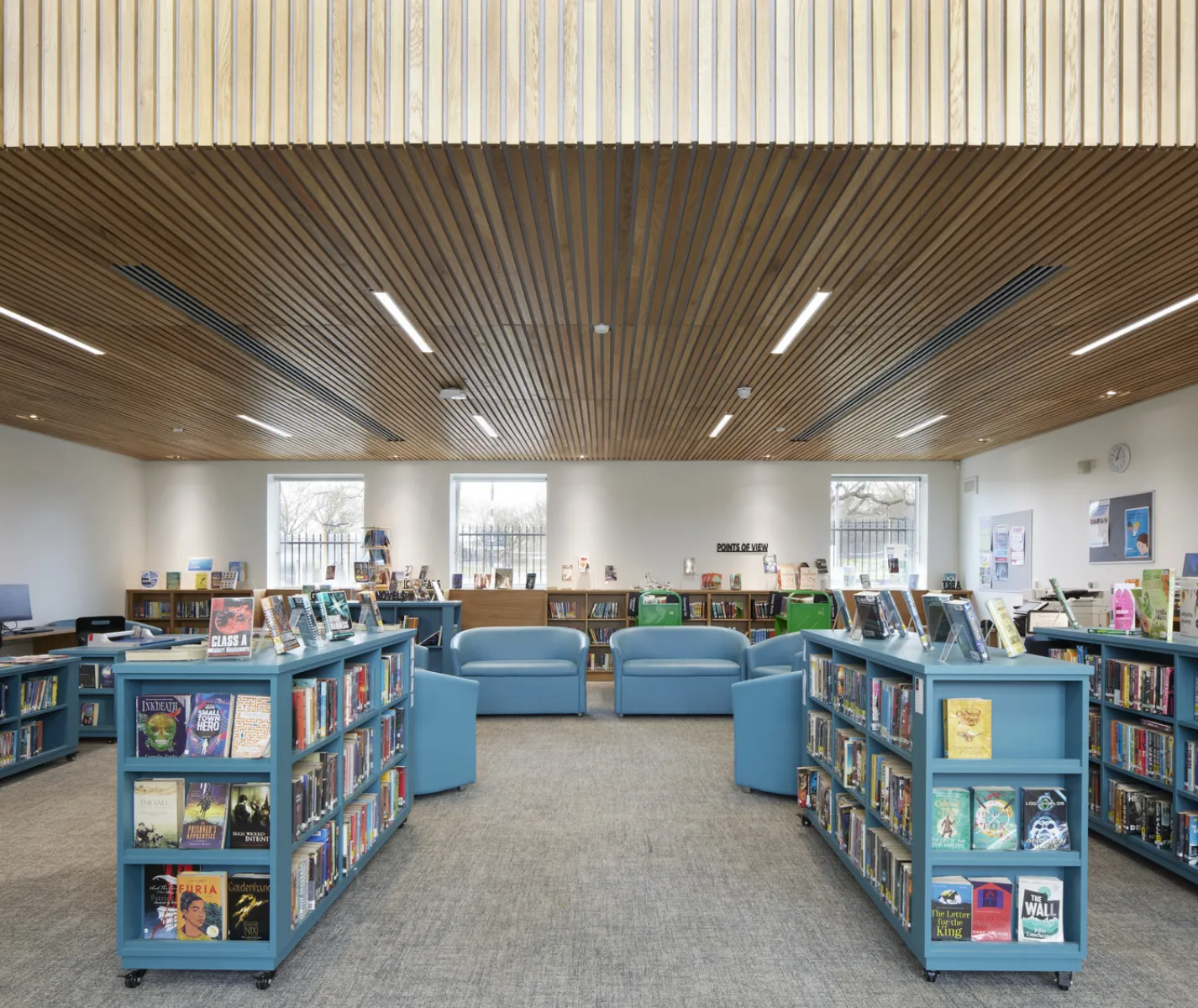 Blue bookcases, with wooden ceiling