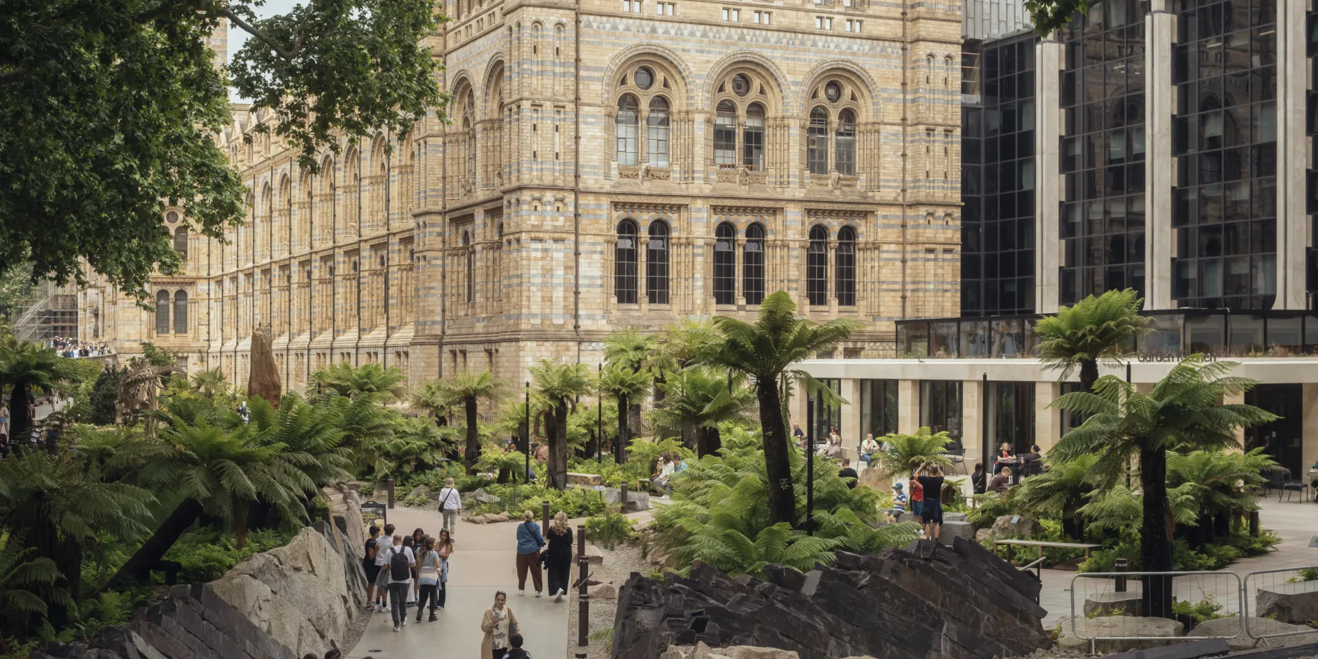 Looking down over visitors in the new gardens at the front of the museum, showing the Garden Kitchen cafe in the distance.