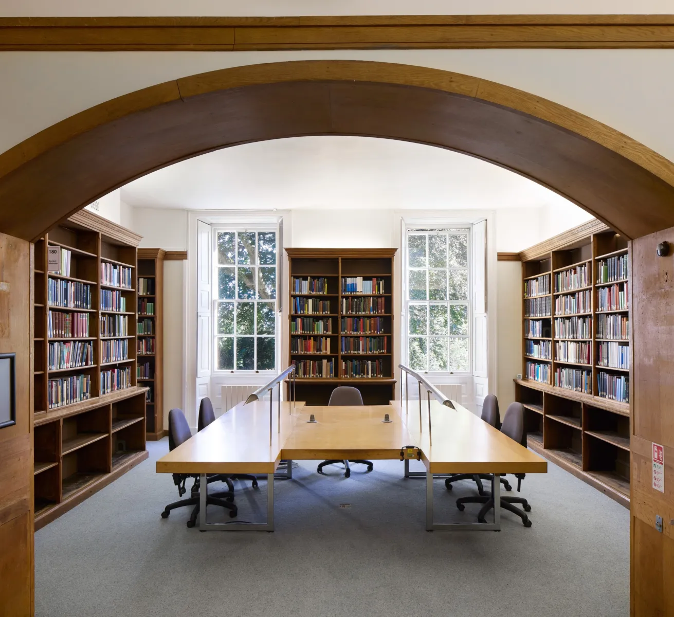 Library with wooden archway and windows
