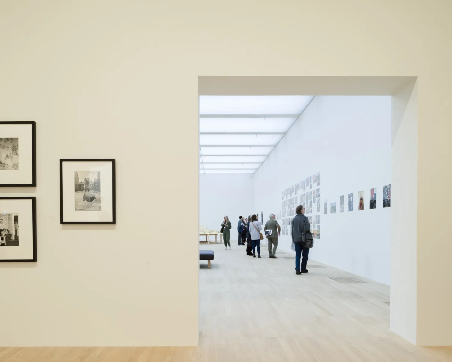 An interior photograph of an art gallery, lit with daylight via roof lights