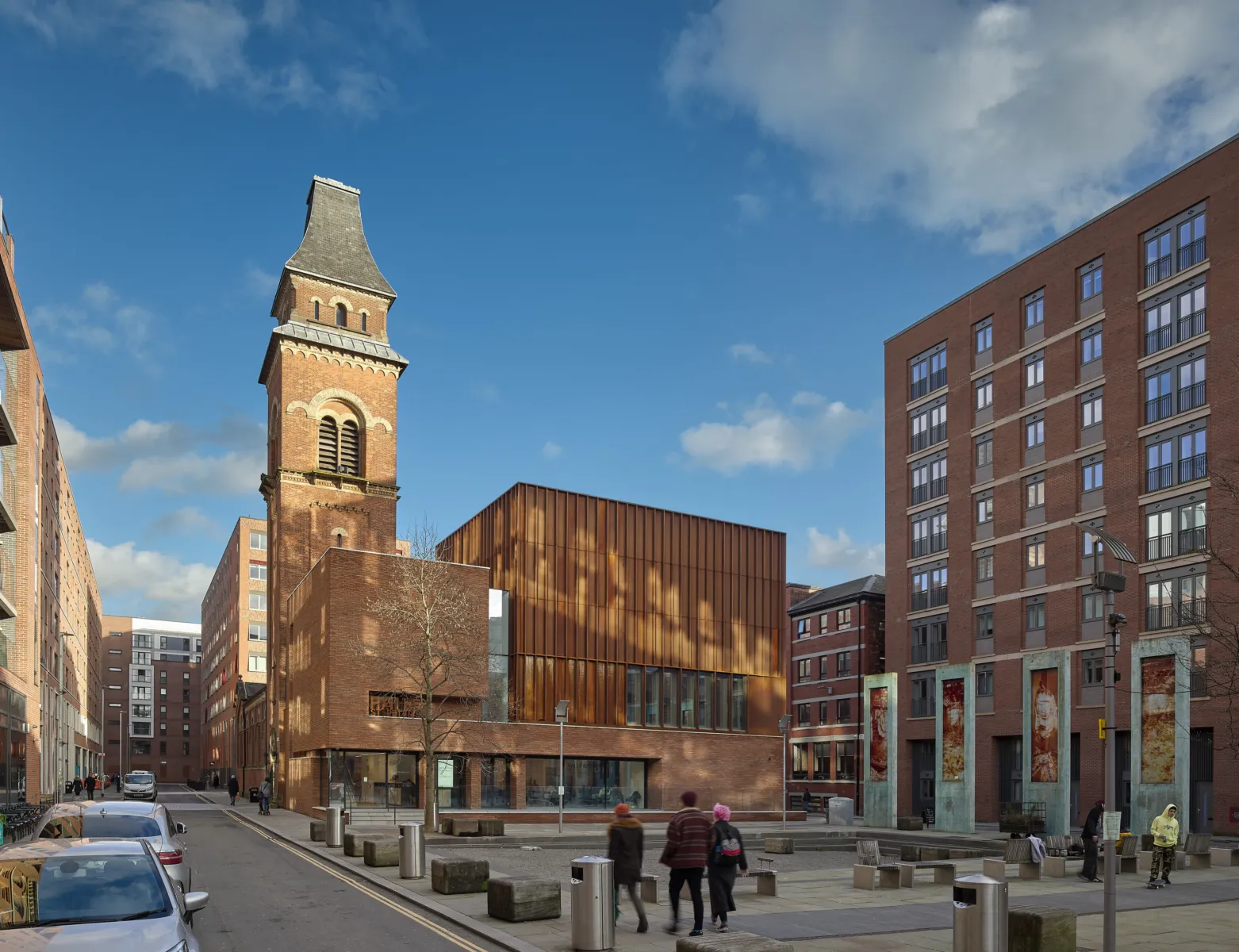A red brick building with a clock tower against blue sky