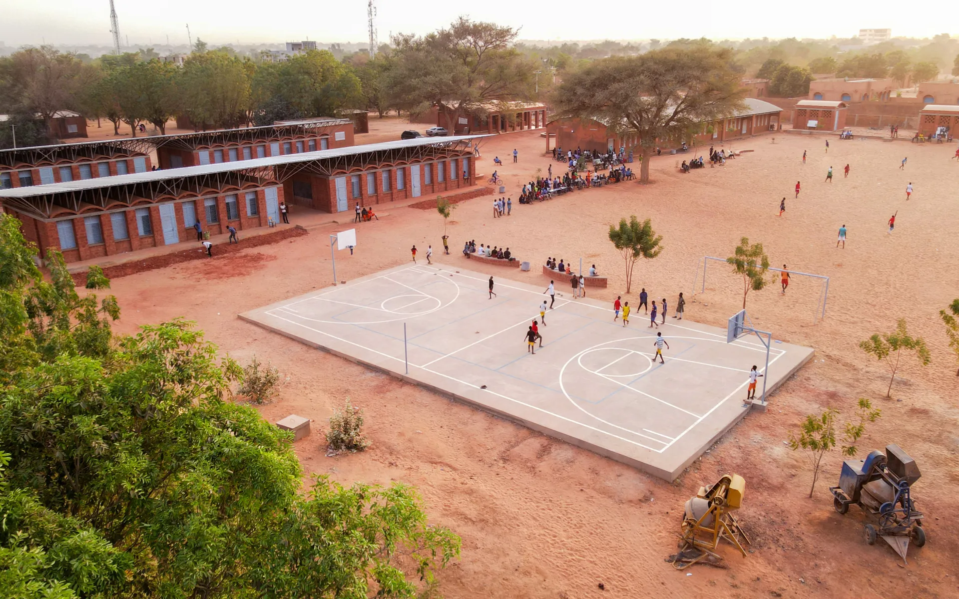 Aerial colour photo of Hampate Ba school football pitch with children playing.