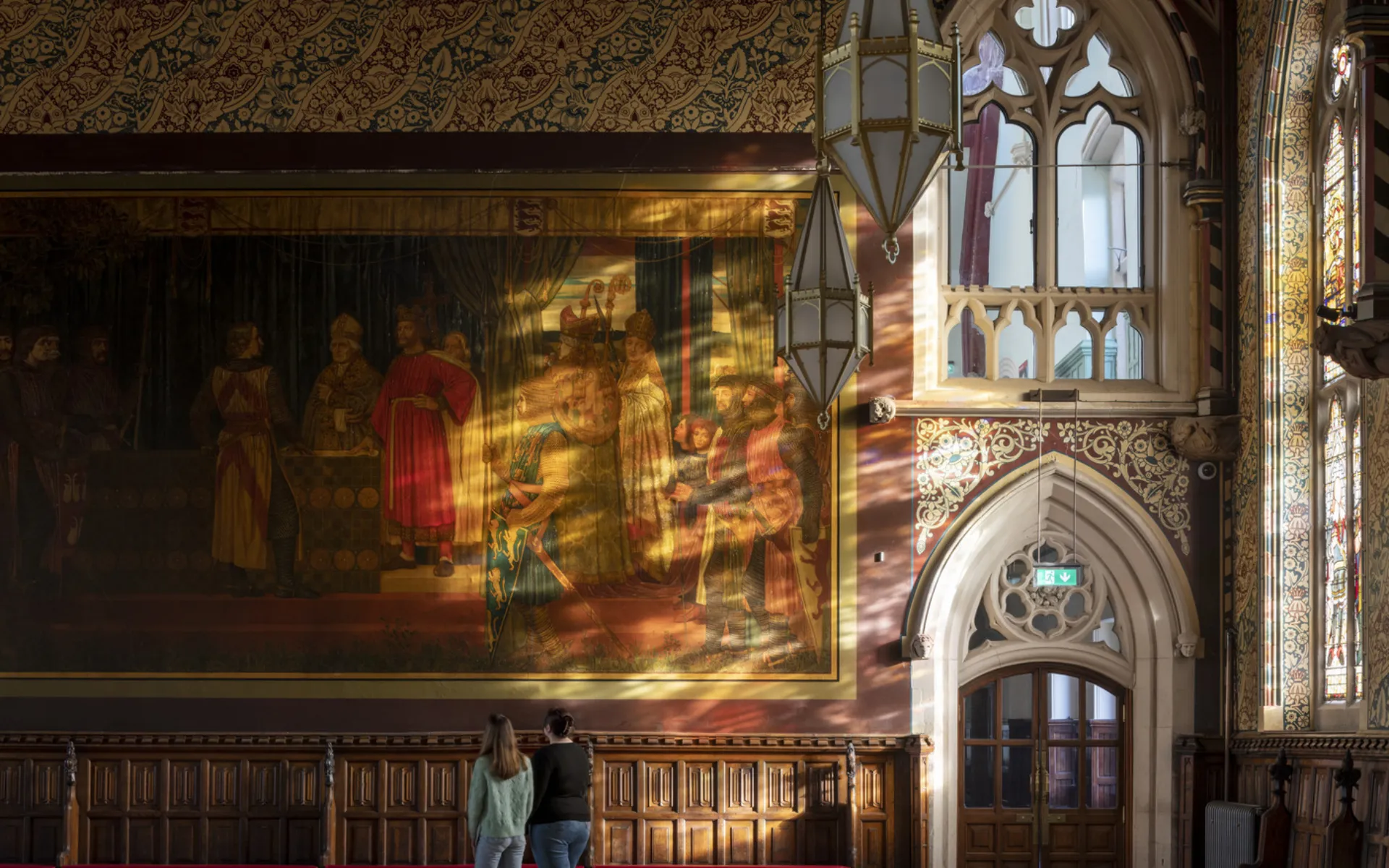 Lighting spills through the arched windows of the hall