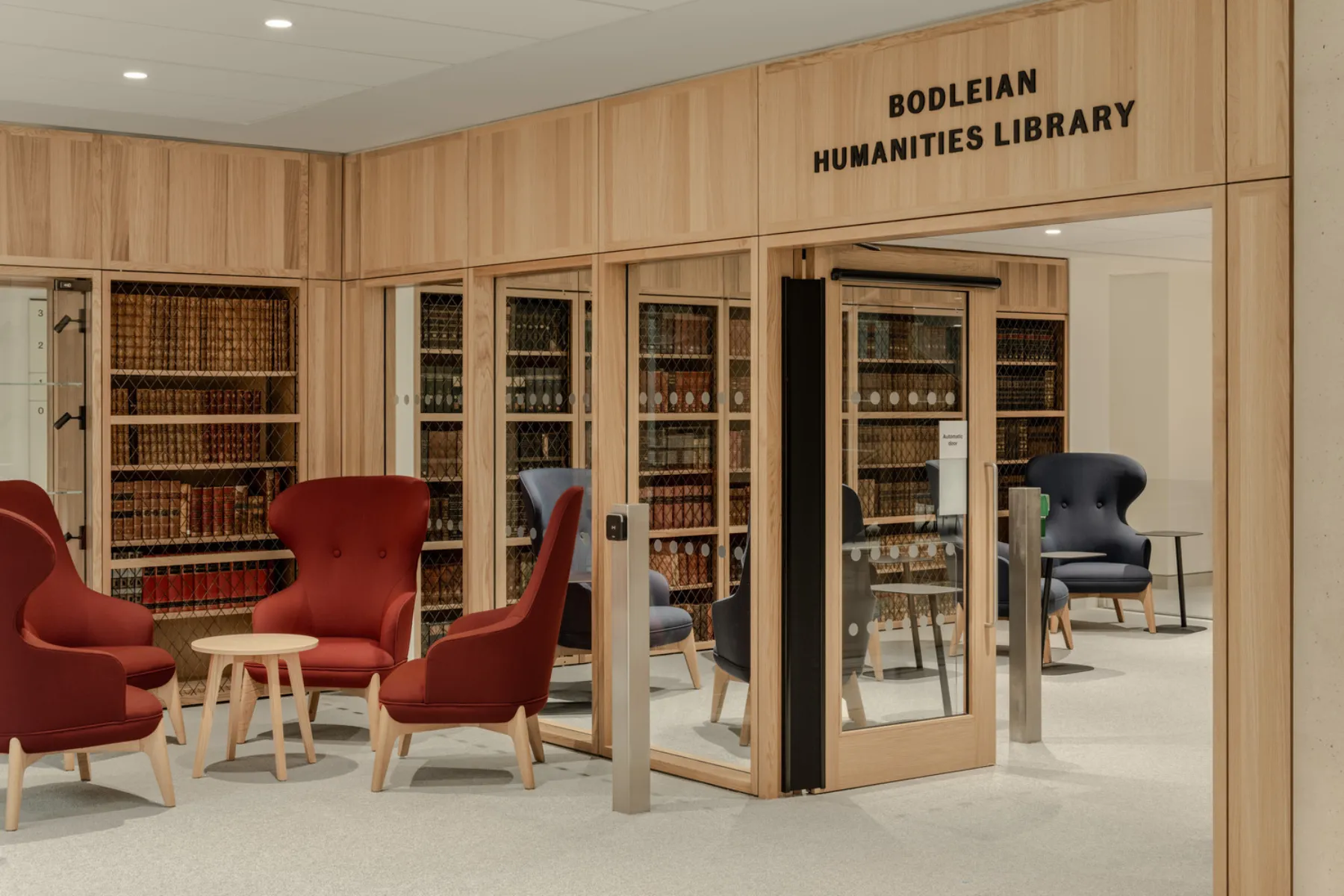 internal entrance to library with red chairs outside of the entrance