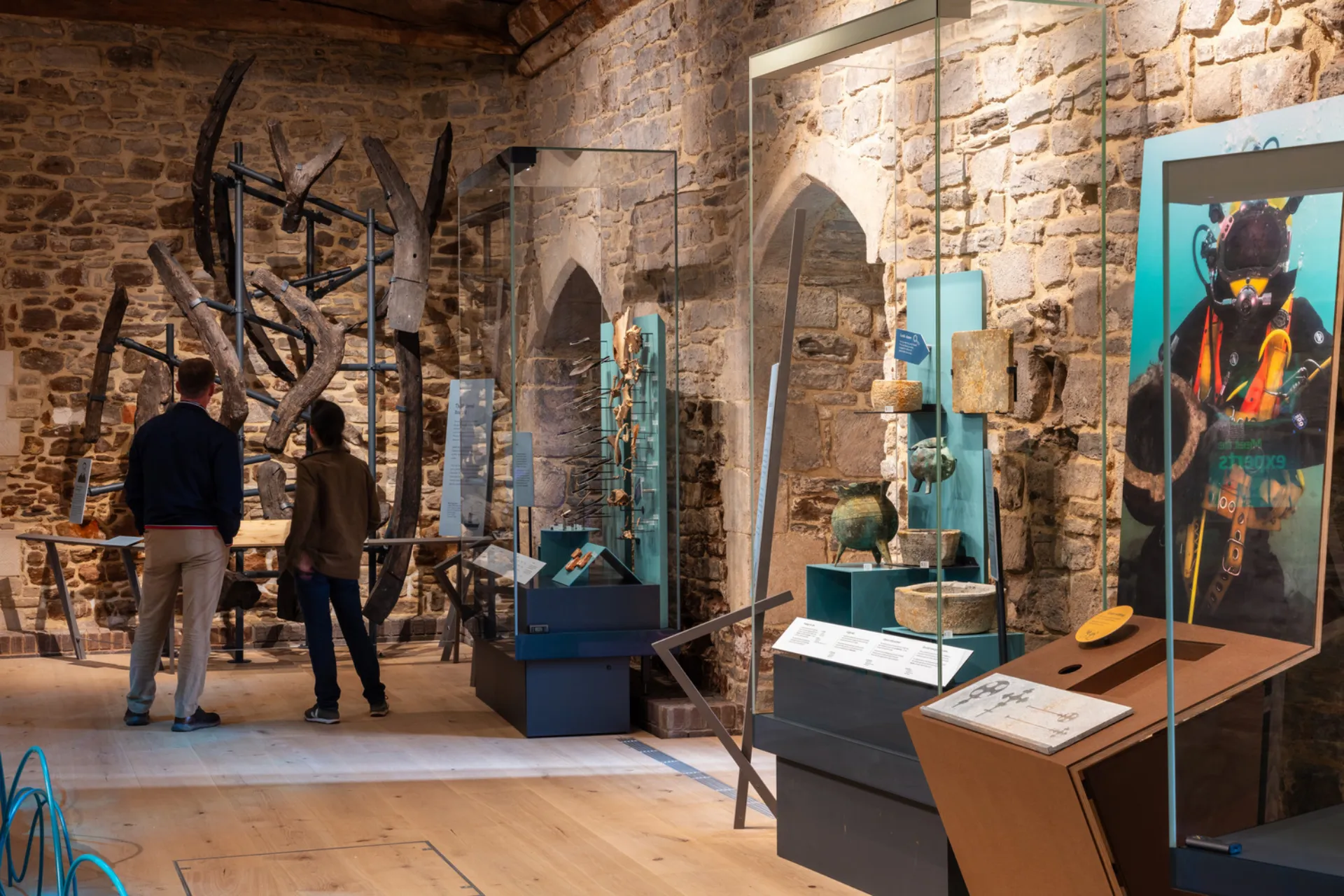 interior of a museum with stone walls showing maritime artefacts