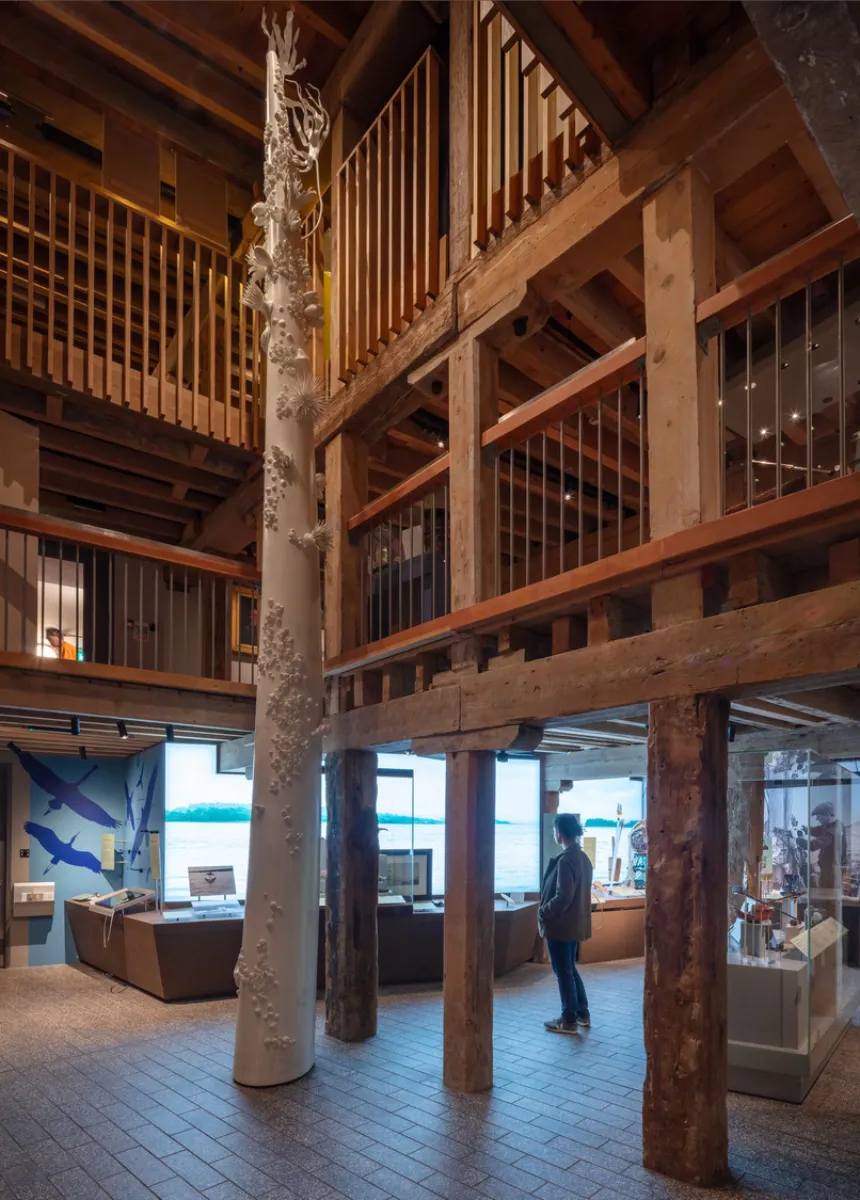 room showing exhibitions and sculpture with multiple levels and old pillars