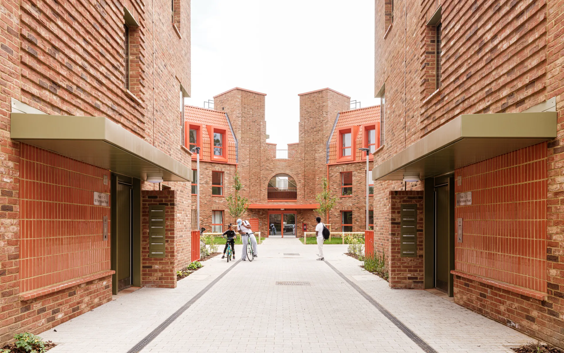 Red brick modern housing with a street in the middle of the image