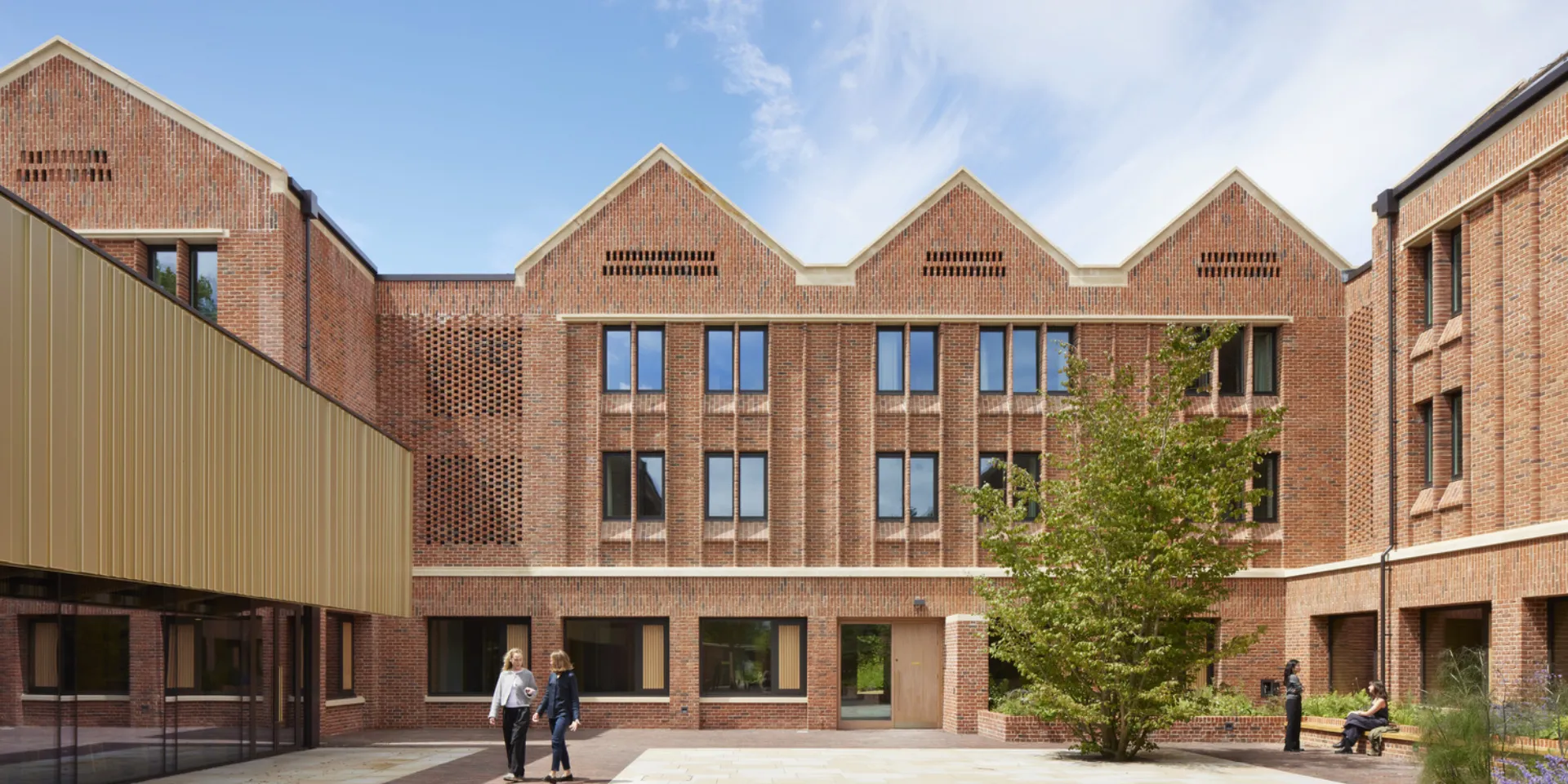 Courtyard view of North House, showing bedroom windows and hit-and-miss brickwork connected to MVHRs.