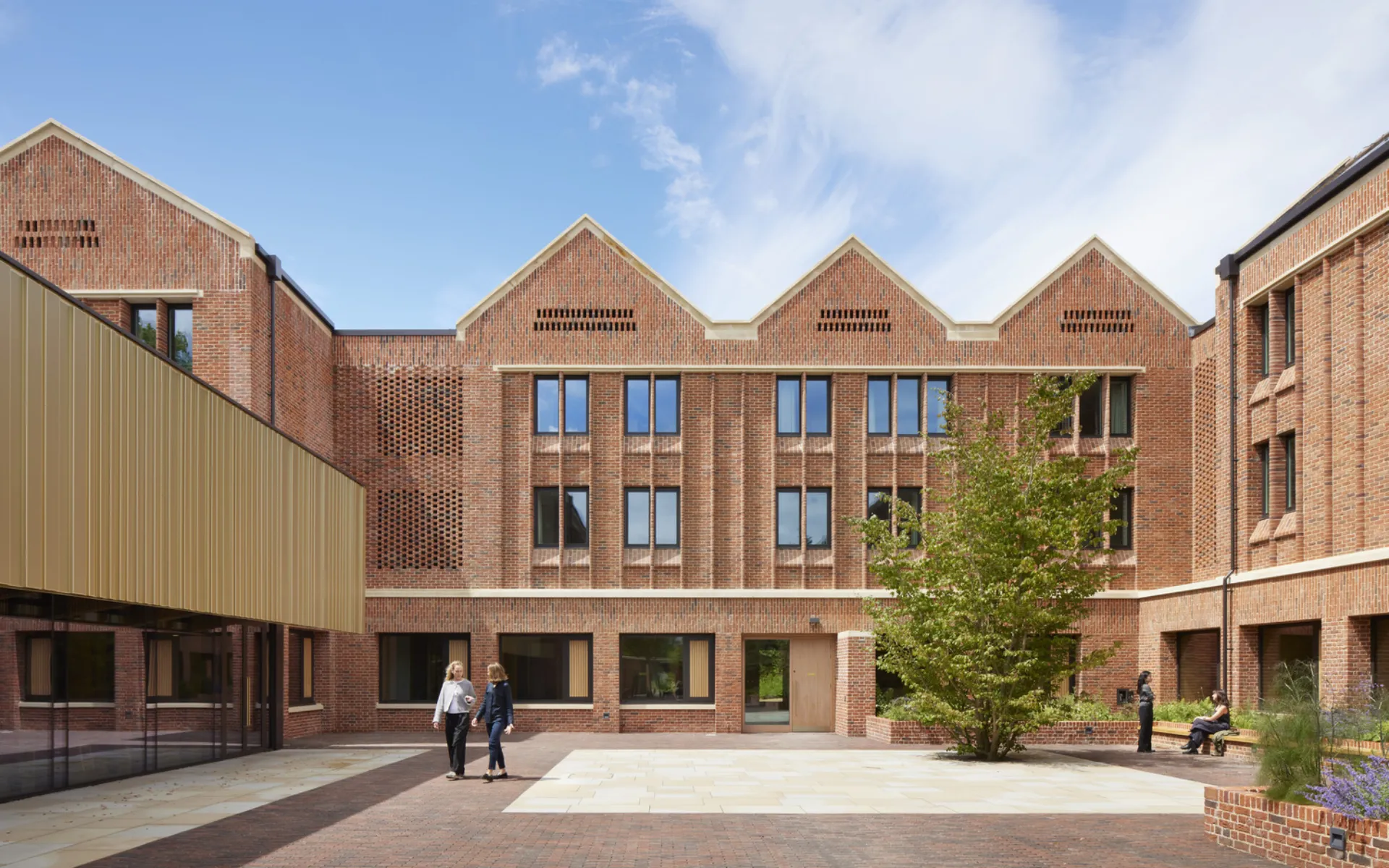 Courtyard view of North House, showing bedroom windows and hit-and-miss brickwork connected to MVHRs.