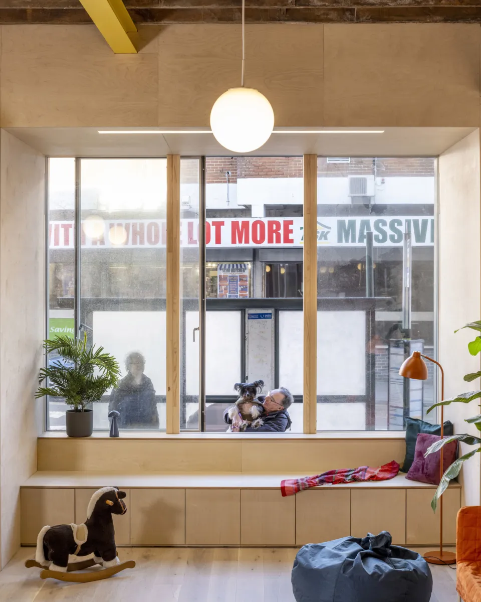 Interior window seat with built-in storage overlooking a busy street.