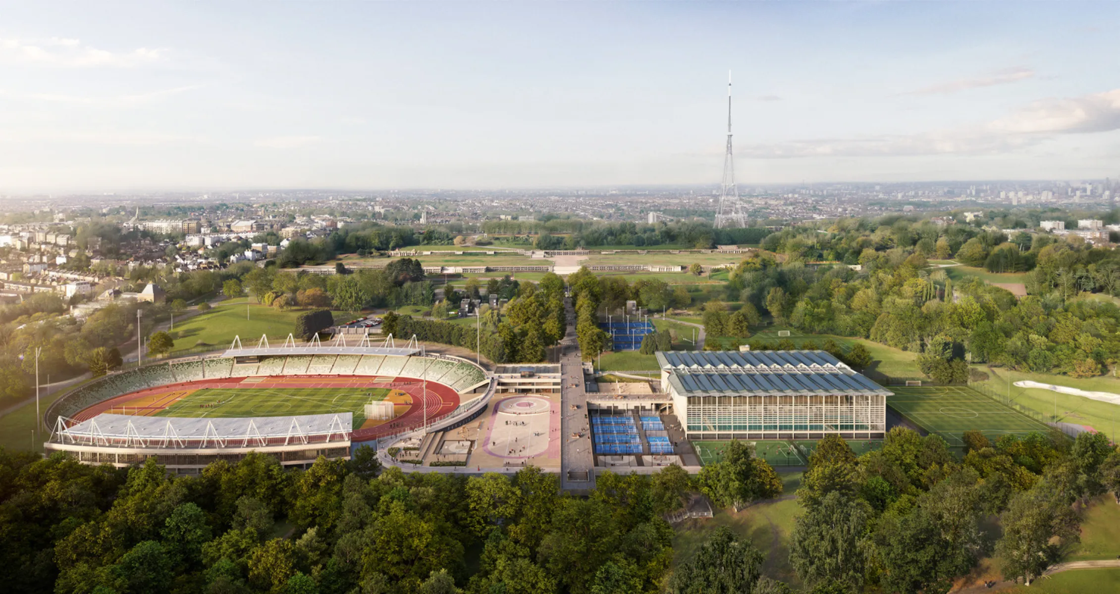 Aerial view of a sports campus with stadium, indoor arena and surrounding parkland.