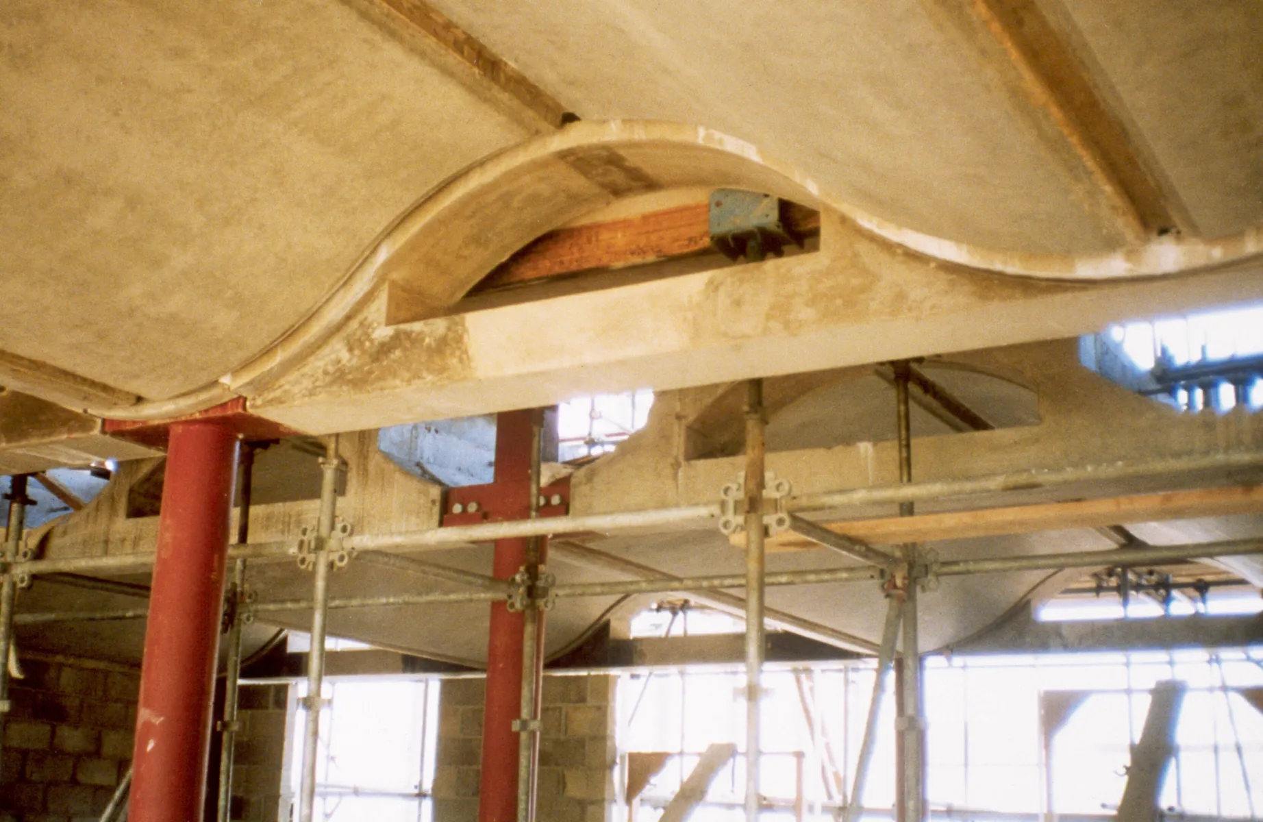 Old colour photo taken during construction of the BRE building in Watford, looking up at the passive ventilation design in the roof.
