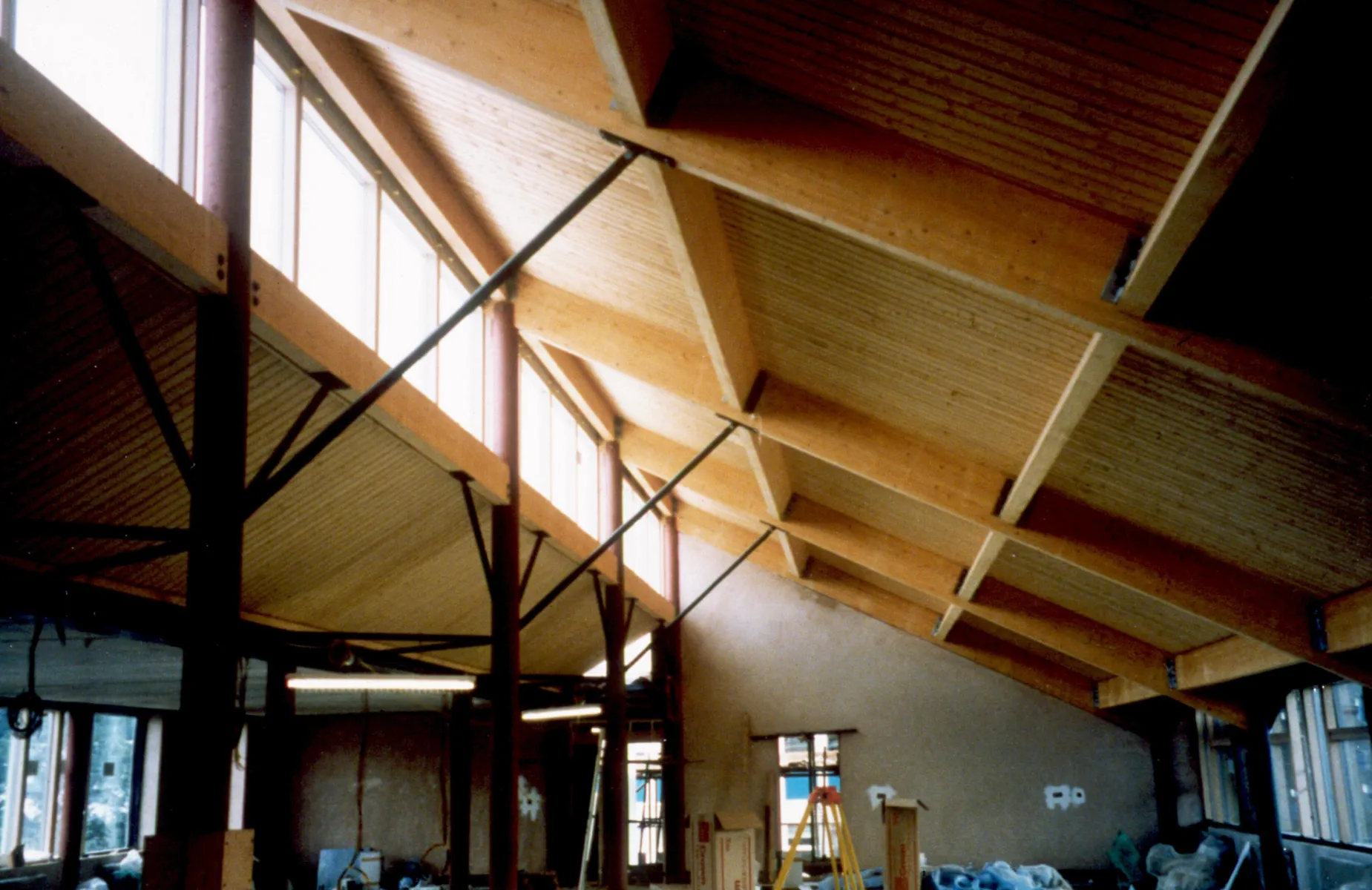 Old colour photo showing newly constructed interior of timber roof and skylights at the BRE offices in Watford.