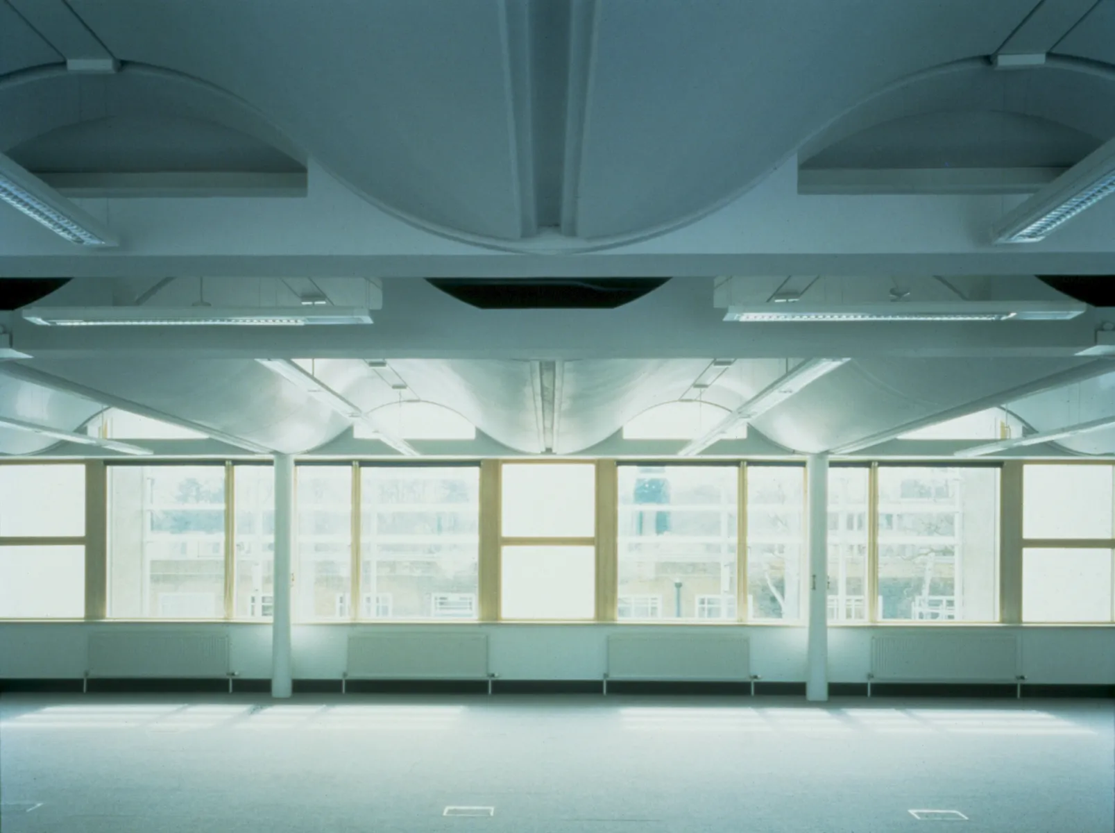 Old colour photo taken inside completed BRE office building in Watford, without furniture.