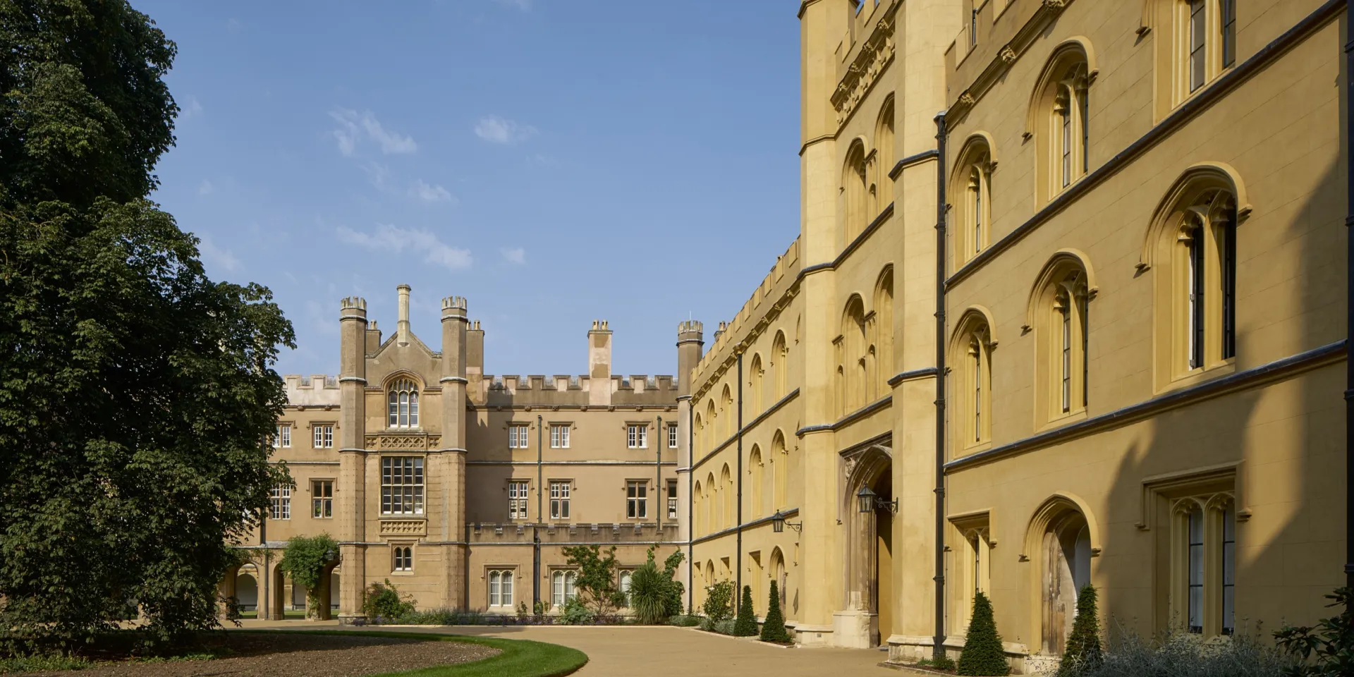 Panoramic view showing the front of Trinity New College in the sunshine