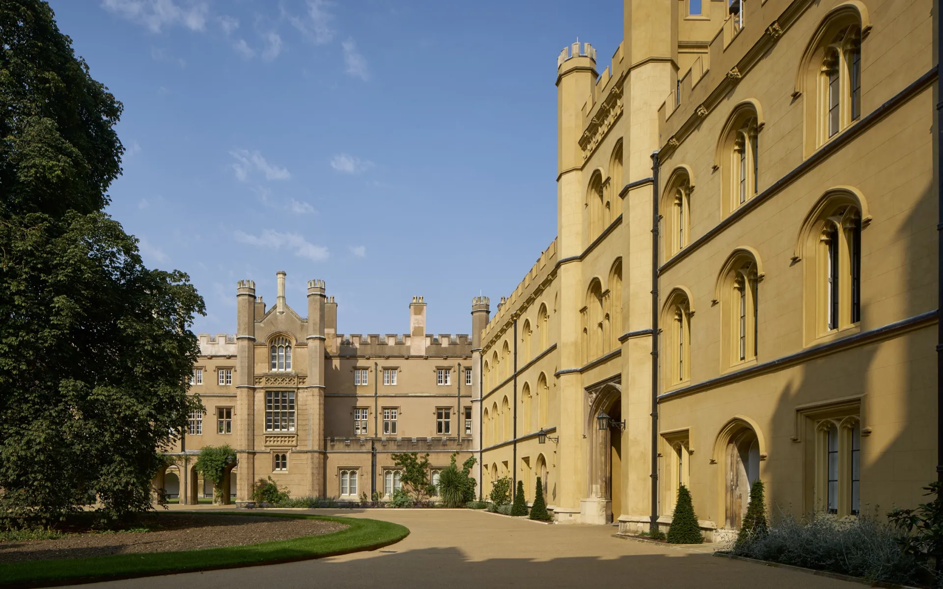 Panoramic view showing the front of Trinity New College in the sunshine