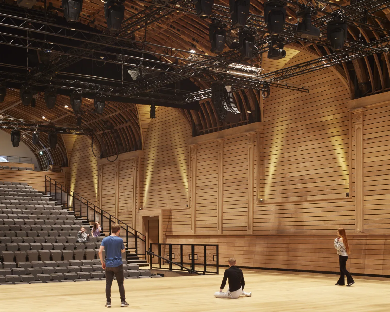 A group of people standing in a spacious auditorium