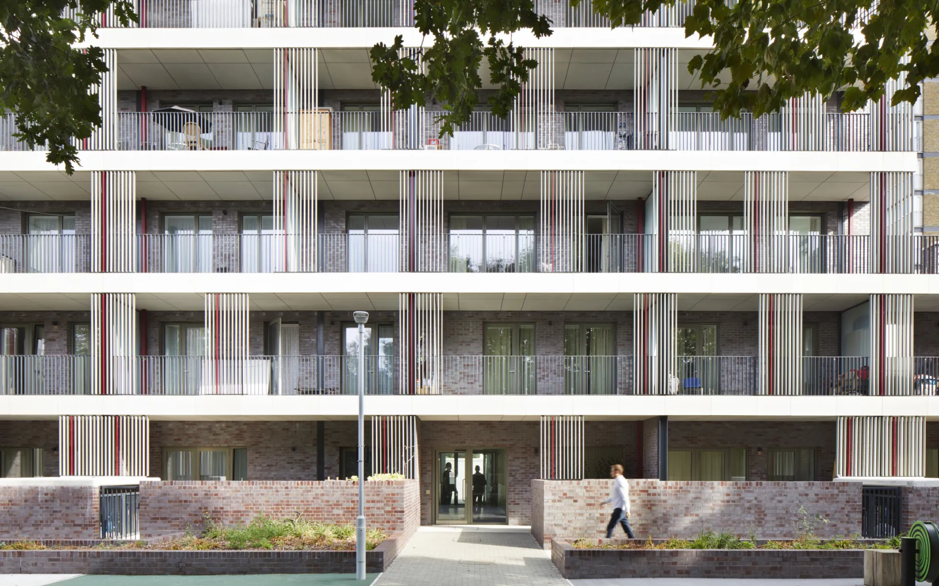A modern multi-story building with a central outdoor space