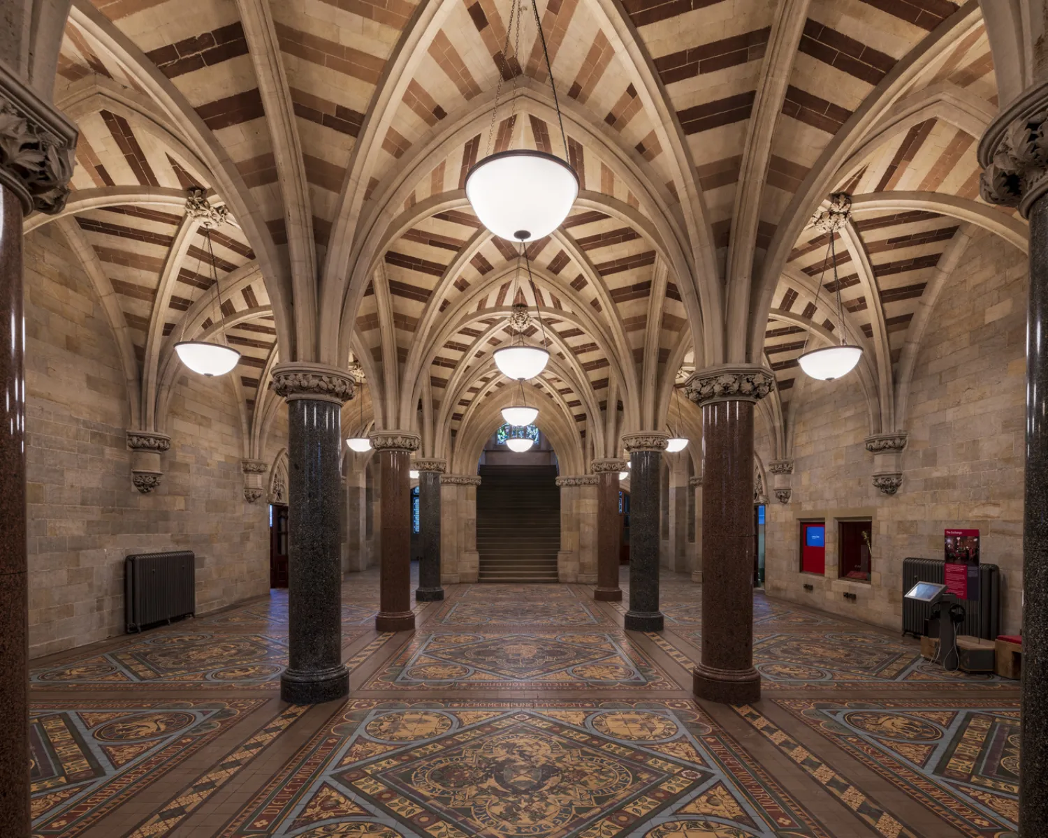 ornate vaulted ceiling with hanging lights and a tiled floor