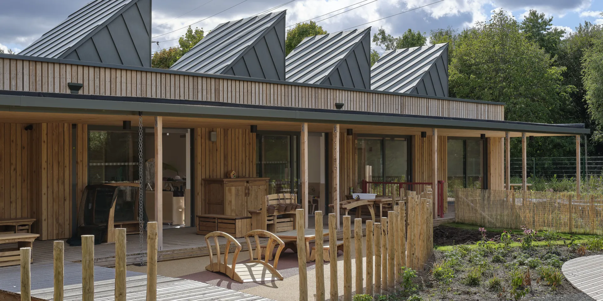 image shows clouds, a blue sky and a wooden building with a fence